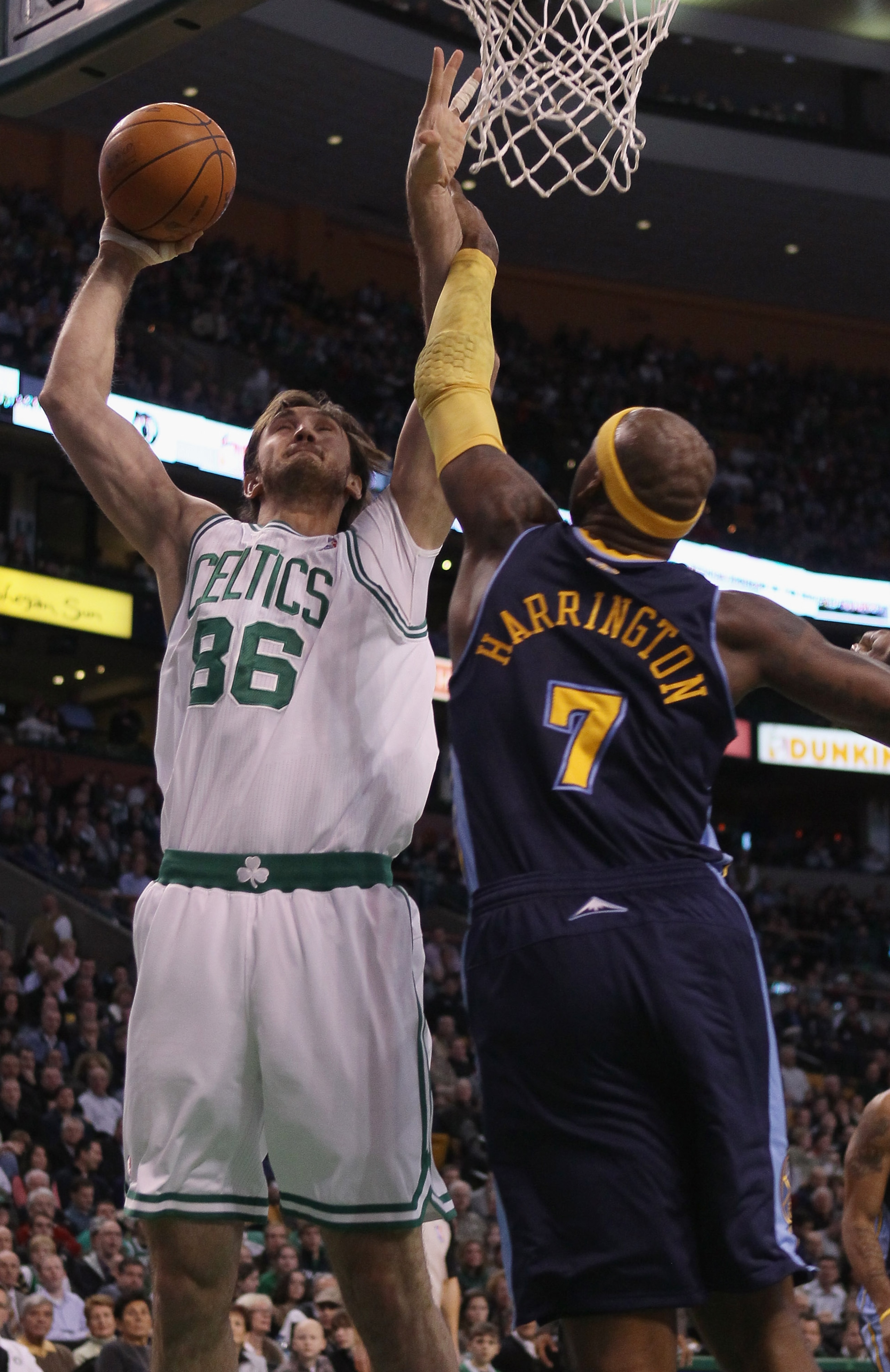 BOSTON, MA - DECEMBER 08: Semih Erden #86 of the Boston Celtics tries to shoot around Al Harrington #7 of the Denver Nuggets on December 8, 2010 at the TD Garden in Boston, Massachusetts. NOTE TO USER: User expressly acknowledges and agrees that, by down BOSTON, MA - DECEMBER 08: Semih Erden #86 of the Boston Celtics tries to shoot around Al Harrington #7 of the Denver Nuggets on December 8, 2010 at the TD Garden in Boston, Massachusetts. NOTE TO USER: User expressly acknowledges and agrees that, by down