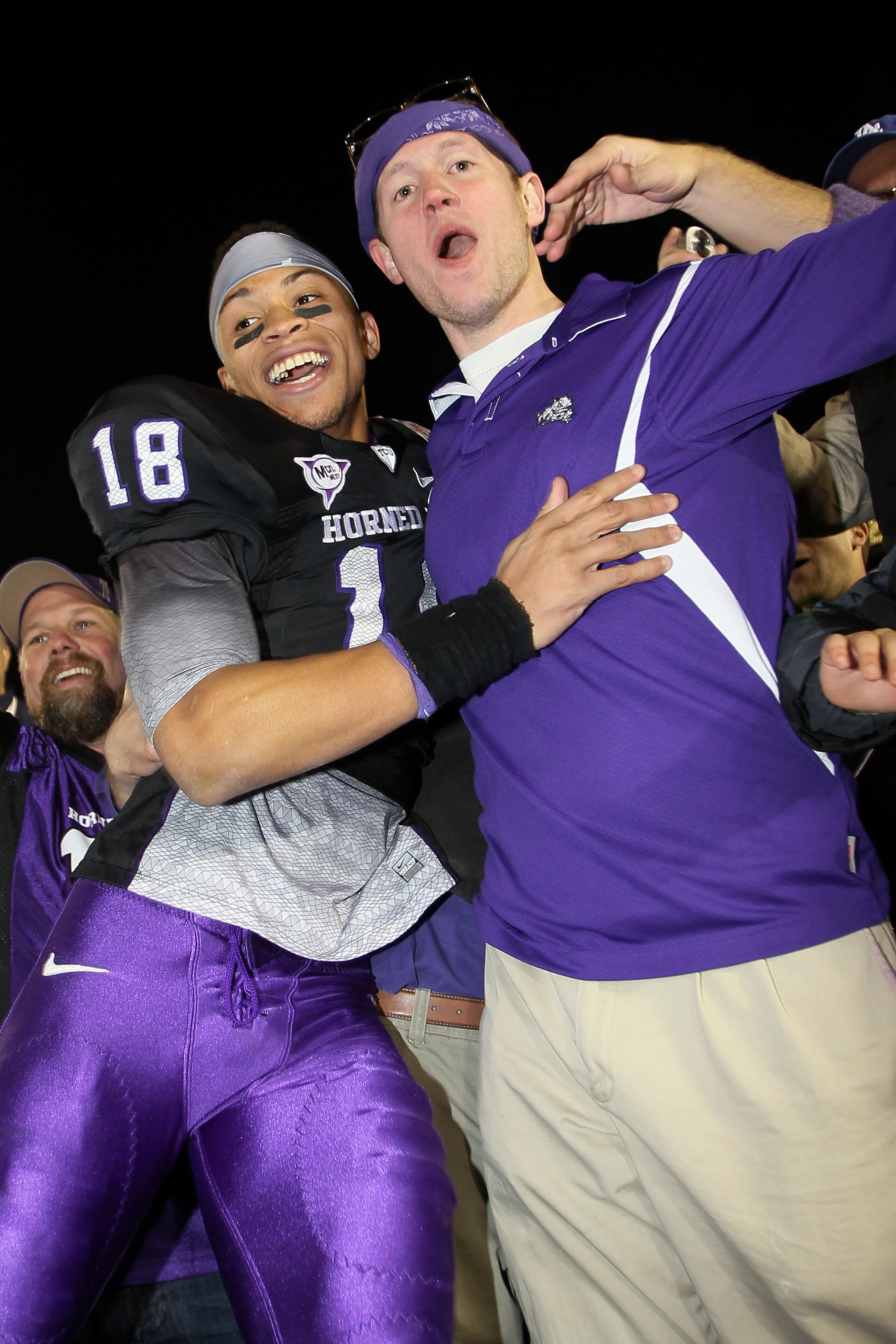 PASADENA, CA - JANUARY 01:  Cornerback Travaras Battle #18 of the TCU Horned Frogs celebrates with a fan after defeating the Wisconsin Badgers 21-19 in the 97th Rose Bowl game on January 1, 2011 in Pasadena, California.  (Photo by Stephen Dunn/Getty Image