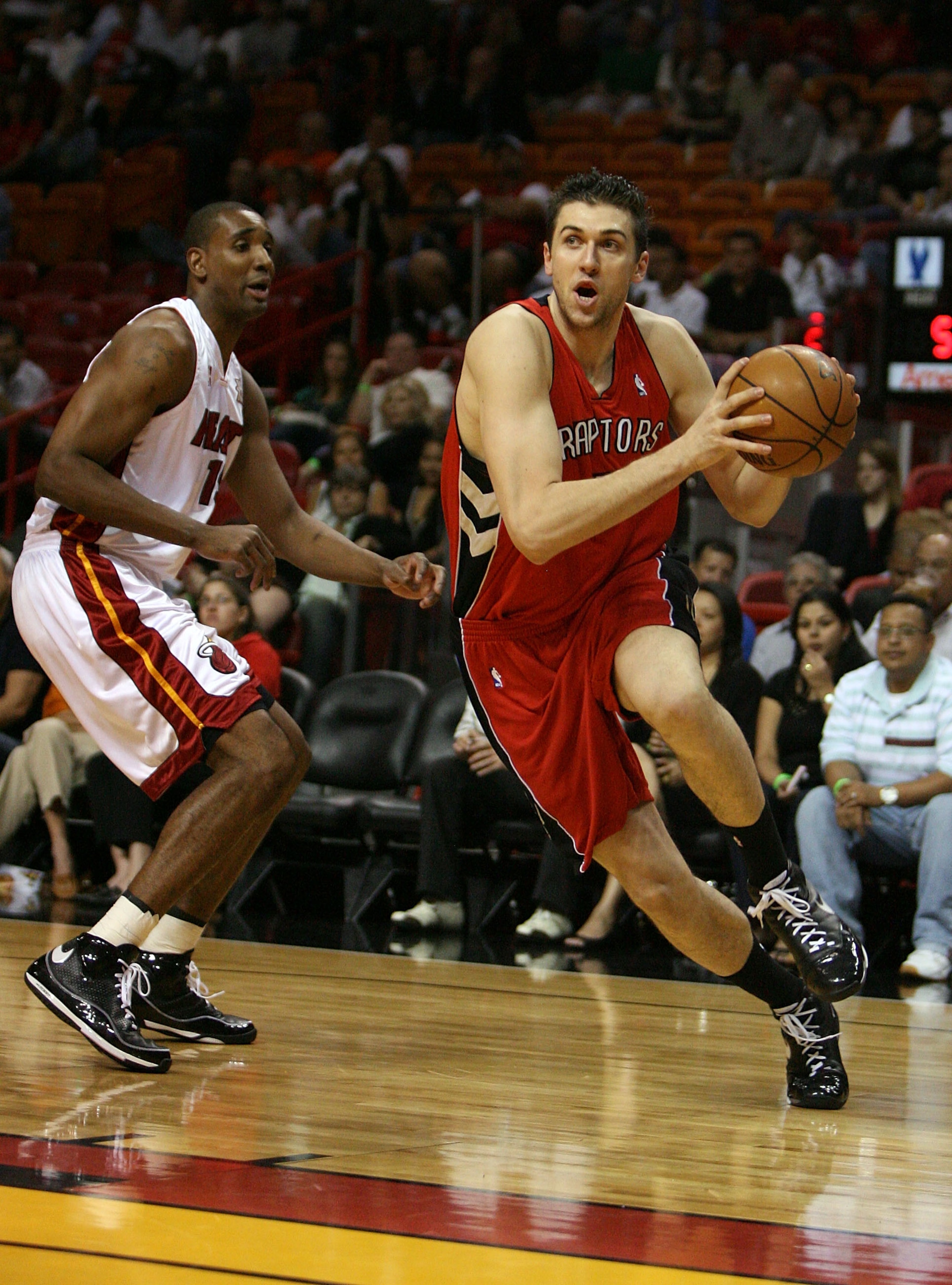 MIAMI - MARCH 05:  Andrea Bargnani #7 of the Toronto Raptors drives past Mark Blount #15 of the Miami Heat at American Airlines Arena on March 5,  2008 in Miami, Florida.  NOTE TO USER: User expressly acknowledges and agrees that, by downloading and or us