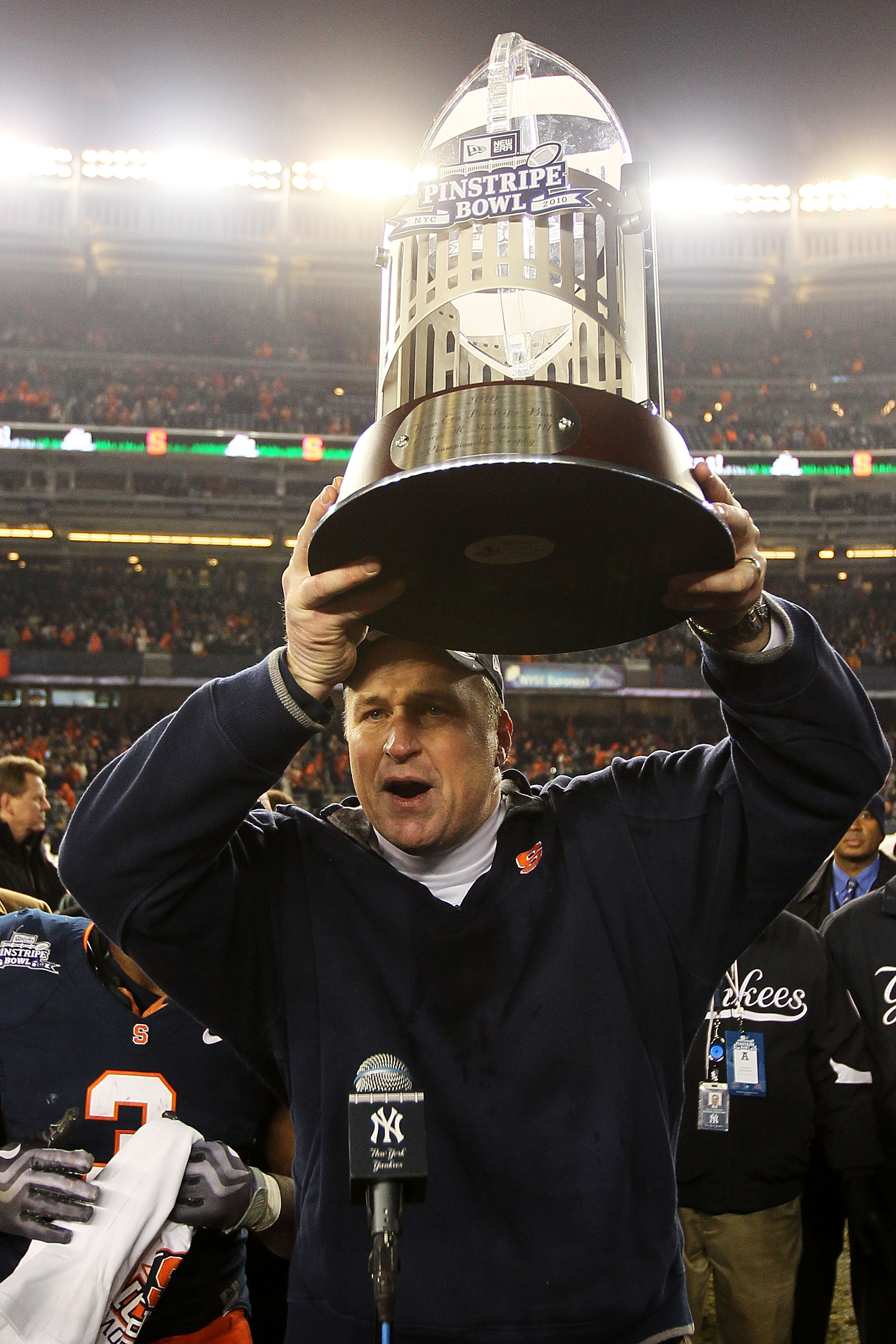NEW YORK, NY - DECEMBER 30:  Syracuse Orange head coach Doug Marrone holds aloft the Pinstripe Bowl trophy after defeating the Kansas State Wildcats during the New Era Pinstripe Bowl at Yankee Stadium on December 30, 2010 in New York, New York.  (Photo by