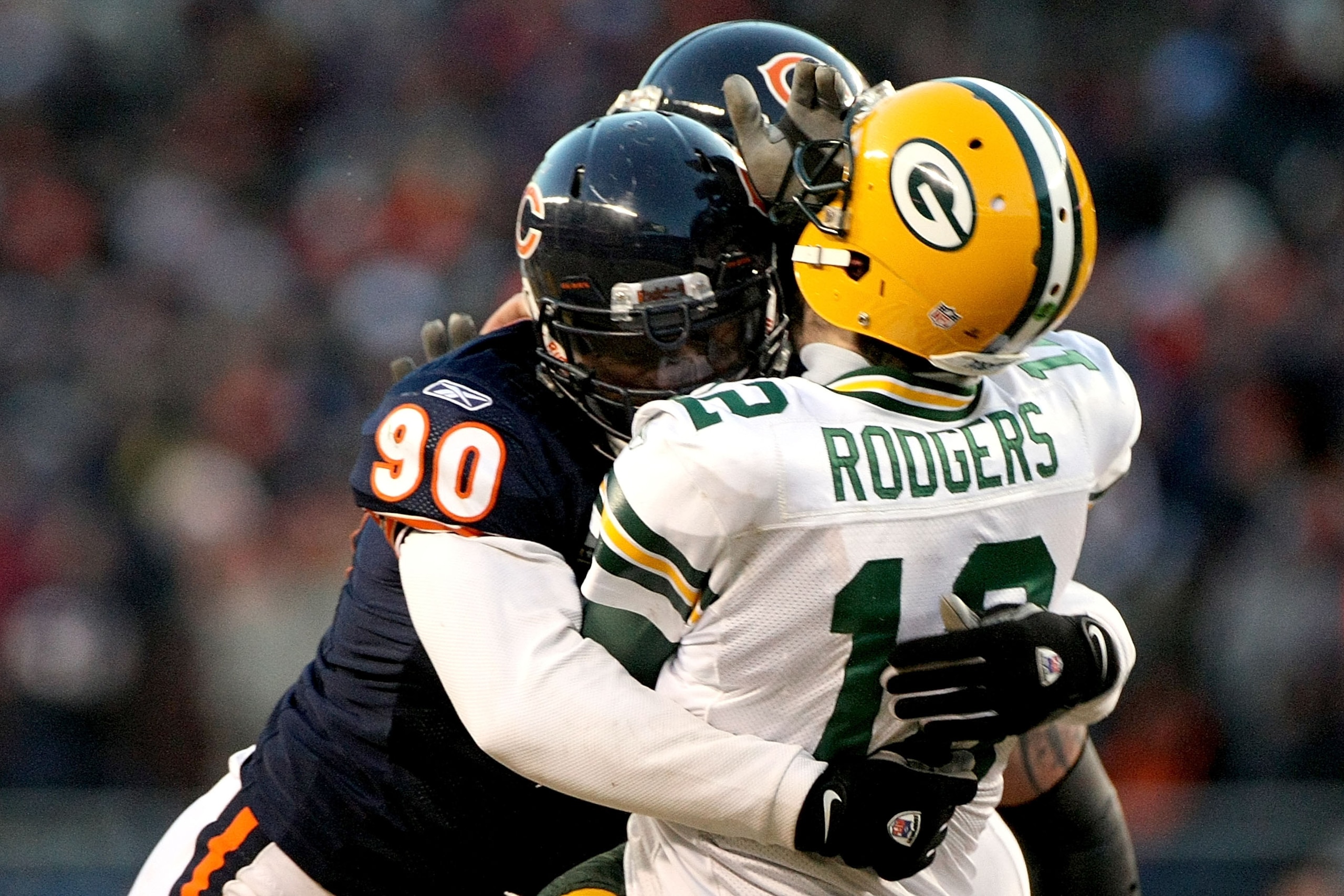 CHICAGO, IL - JANUARY 23: Quarterback Aaron Rodgers #12 of the Green Bay Packers is hit by Julius Peppers #90 of the Chicago Bears in the helmet as Peppers was called for a personal foul in the fourth quarter of the NFC Championship Game at Soldier Field CHICAGO, IL - JANUARY 23: Quarterback Aaron Rodgers #12 of the Green Bay Packers is hit by Julius Peppers #90 of the Chicago Bears in the helmet as Peppers was called for a personal foul in the fourth quarter of the NFC Championship Game at Soldier Field