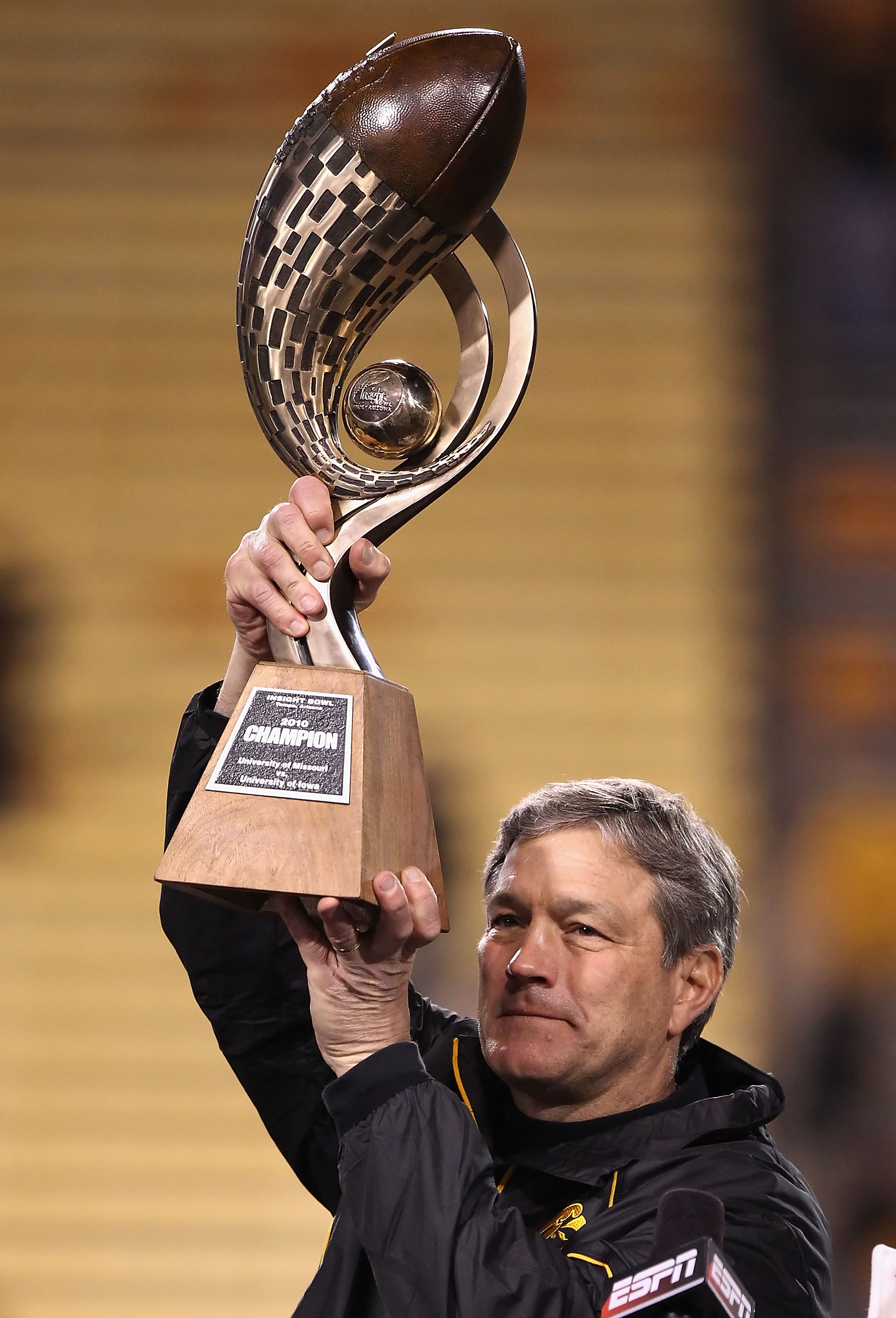 TEMPE, AZ - DECEMBER 28:  Head coach Kirk Ferentz of the Iowa Hawkeyes celebrates with the  Insight Bowl trophy after defeating the Missouri Tigers at Sun Devil Stadium on December 28, 2010 in Tempe, Arizona.  The Hawkeyes defeated the Tigers 27-24.  (Pho