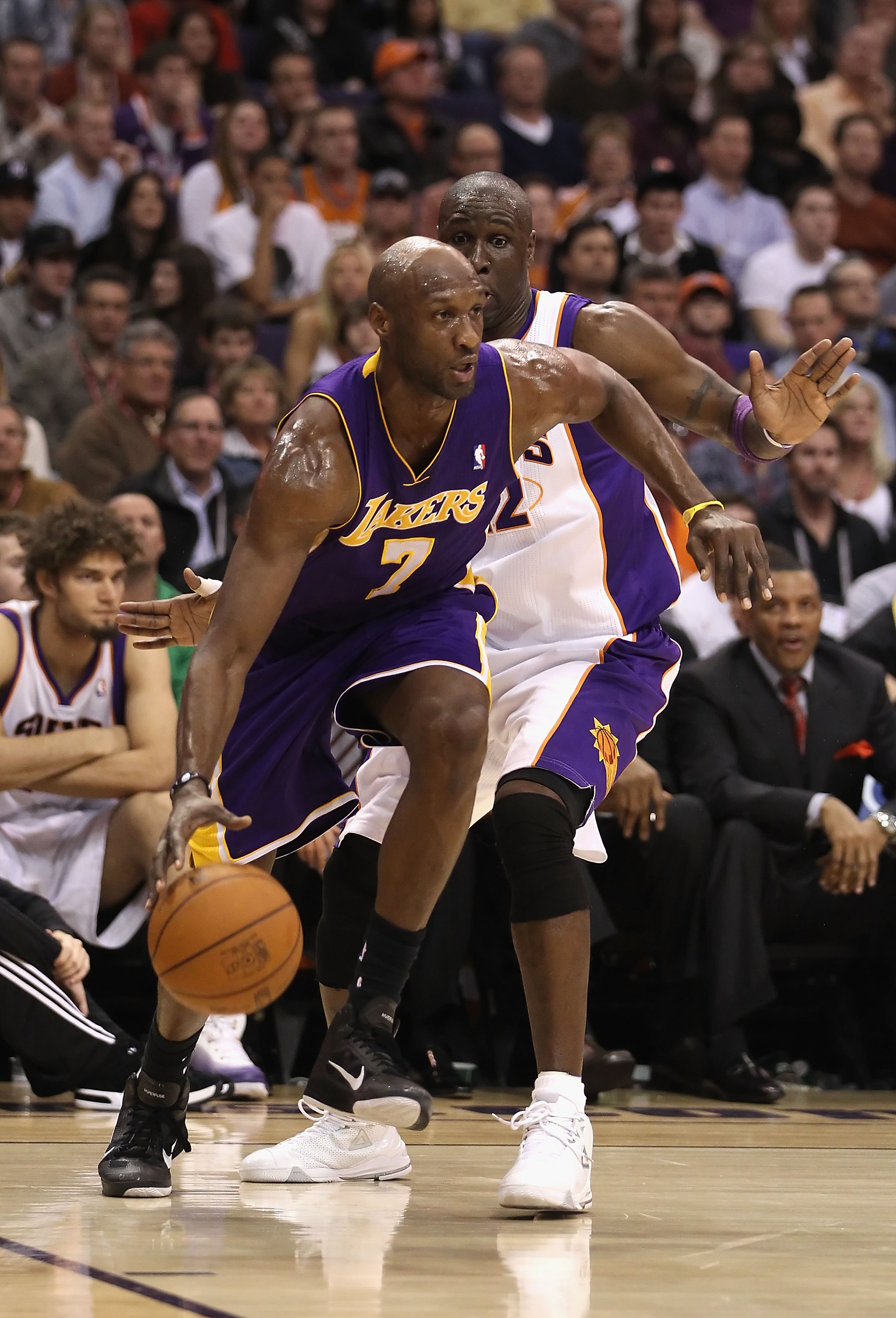 PHOENIX, AZ - JANUARY 05:  Lamar Odom #7 of the Los Angeles Lakers handles the ball during the NBA game against the Phoenix Suns at US Airways Center on December 23, 2011 in Phoenix, Arizona. The Lakers defeated the Suns 99-95.  NOTE TO USER: User express