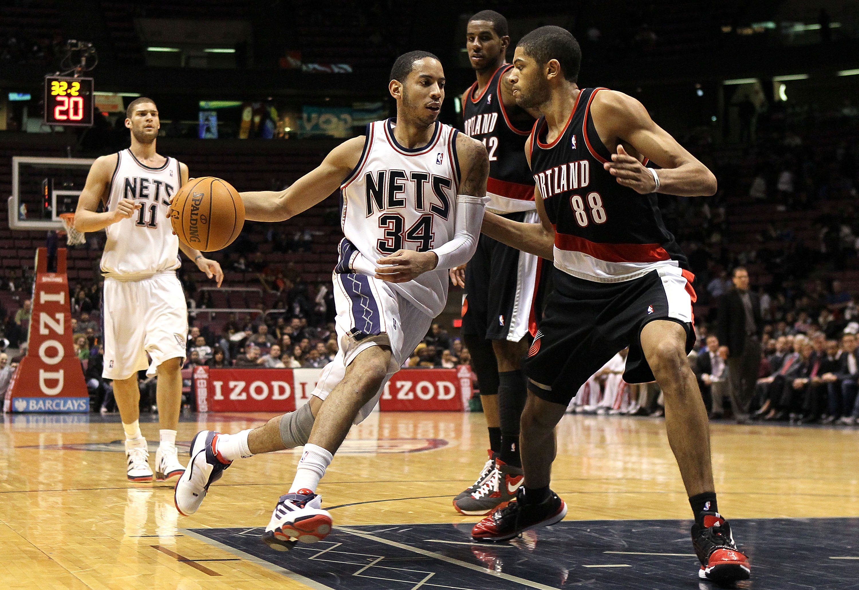 EAST RUTHERFORD, NJ - FEBRUARY 23:  Devin Harris #34 of the New Jersey Nets drives against Nicolas Batum #88 of the Portland Trail Blazers at the Izod Center on February 23, 2010 in East Rutherford, New Jersey.The Blazers defeated the Nets 102-93.NOTE TO