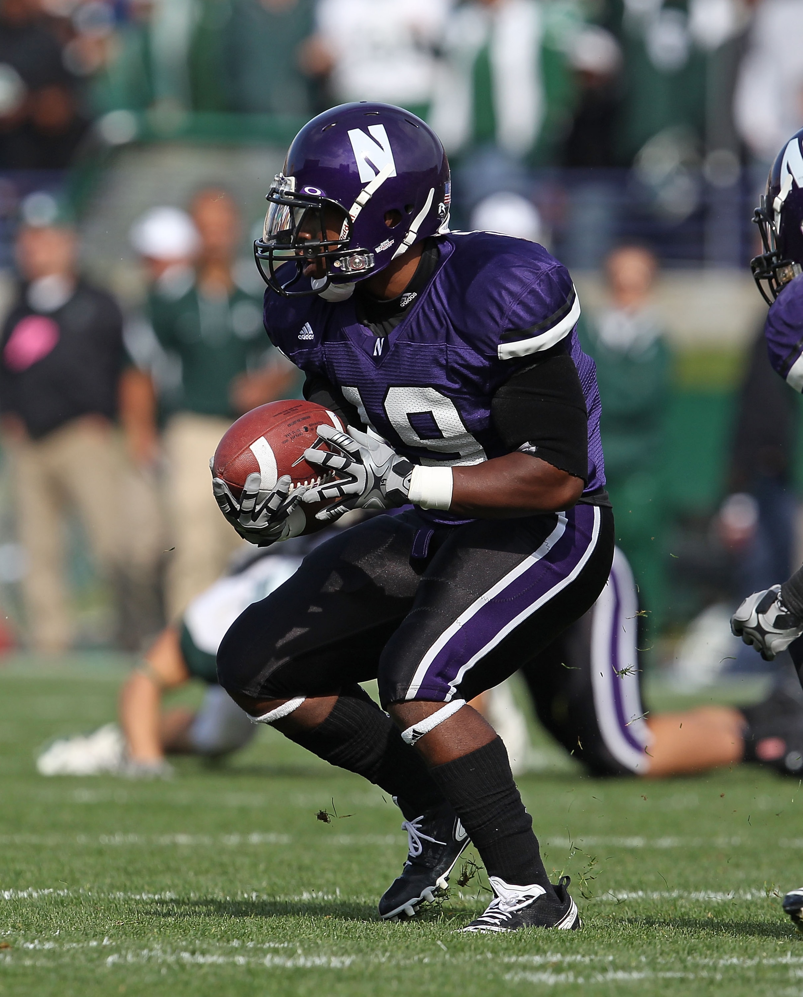 EVANSTON, IL - OCTOBER 23: Arby Fields #19 of the Northwestern Wildcats looks for running room against the Michigan State Spartans at Ryan Field on October 23, 2010 in Evanston, Illinois. Michigan State defeated Northwestern 35-27. (Photo by Jonathan Dani