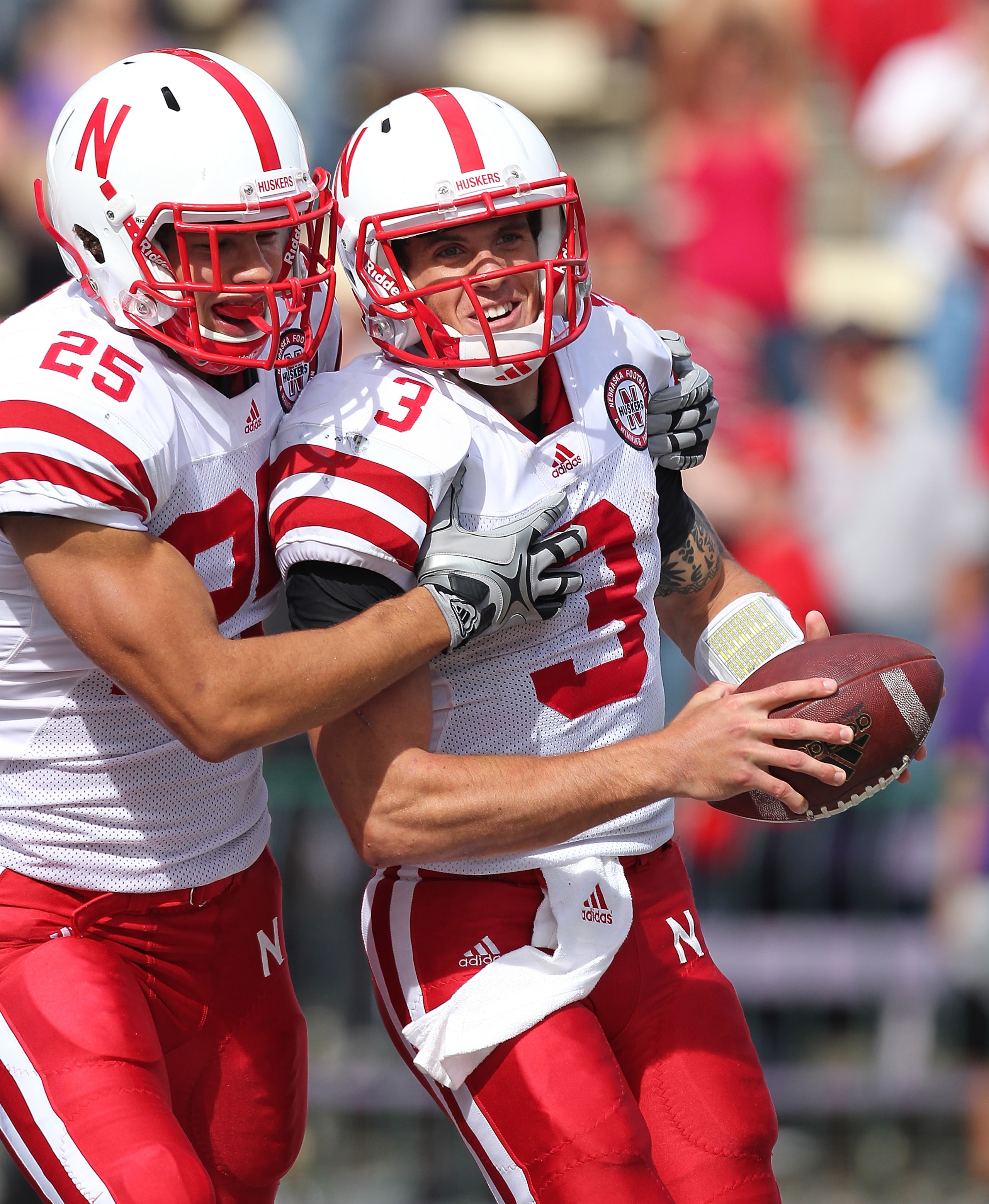 SEATTLE - SEPTEMBER 18:  Quarterback Taylor Martinez #3 of the Nebraska Cornhuskers celebrates with Kyler Reed #25 after scoring on an 80 yard touchdown run in the third quarter against the Washington Huskies on September 18, 2010 at Husky Stadium in Seat