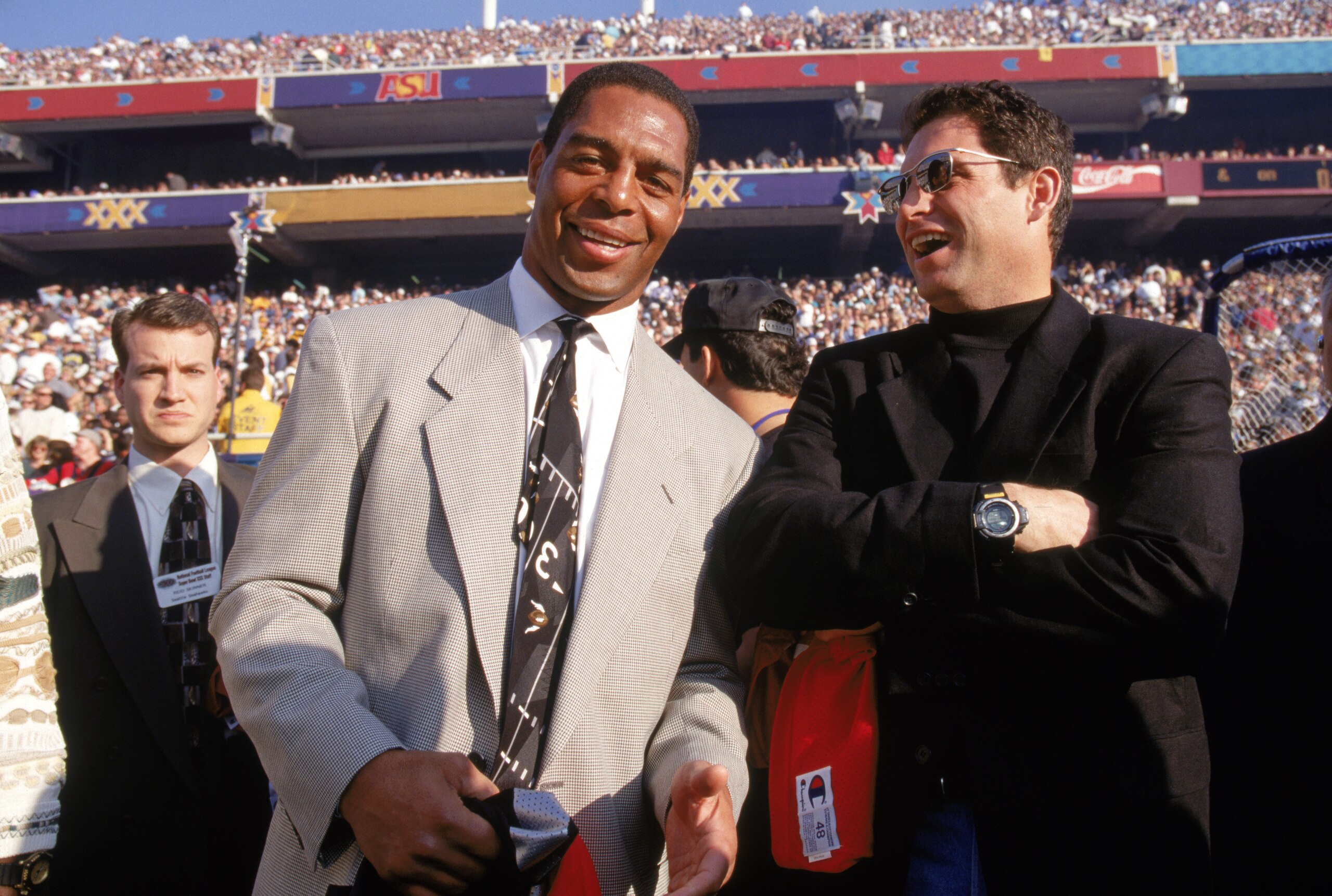 TEMPE, AZ - JANUARY 28:  Kansas City Chiefs running back Marcus Allen and quarterback Steve Young of the San Francisco 49ers pose for a photo on the field as they participate in pre game festivities during Super Bowl XXX between the Dallas Cowboys and the