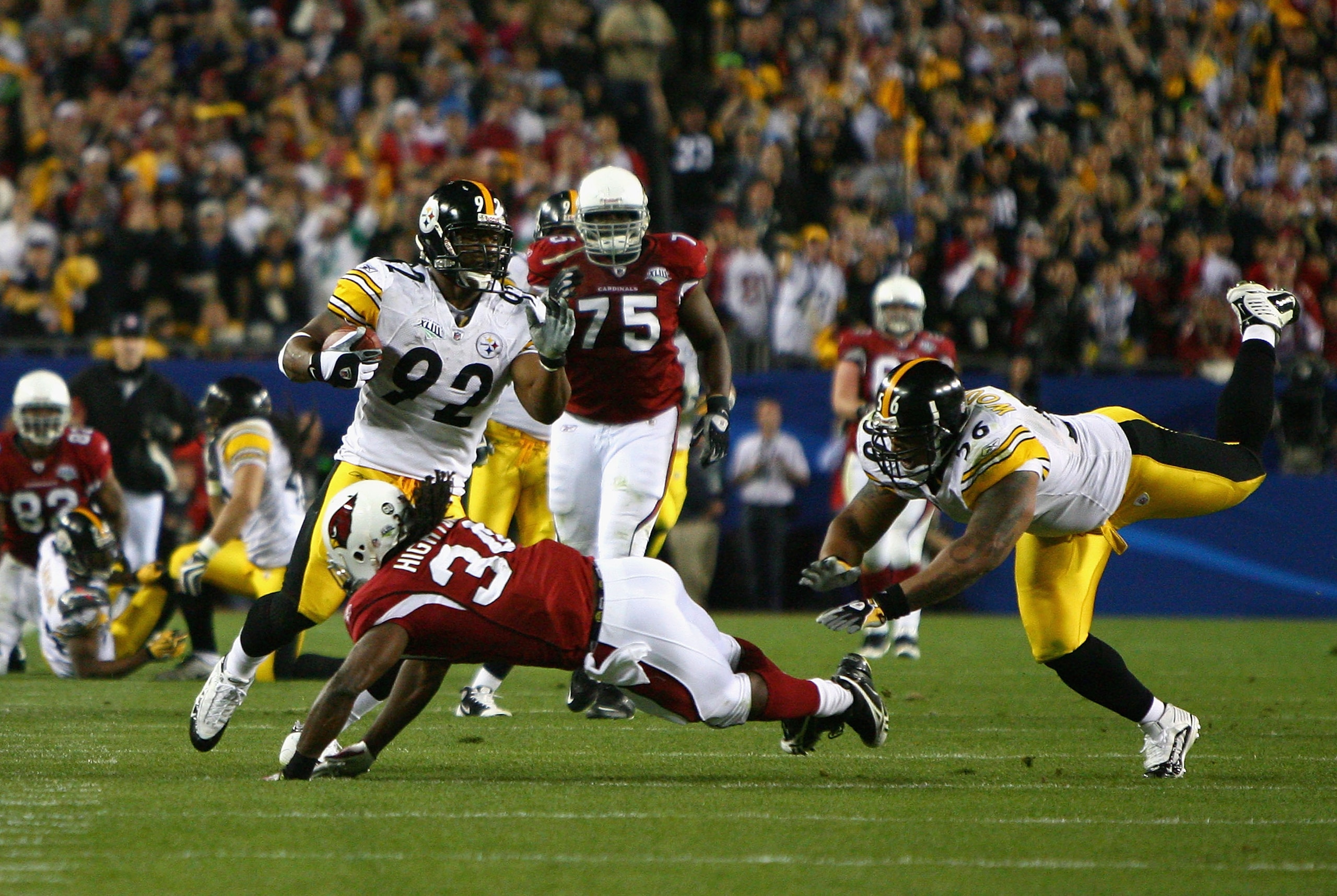 TAMPA, FL - FEBRUARY 01:  James Harrison #92 of the Pittsburgh Steelers runs back an interception for 100 yards to score a touchdown in the second quarter against Tim Hightower #34 of the Arizona Cardinals during Super Bowl XLIII on February 1, 2009 at Ra