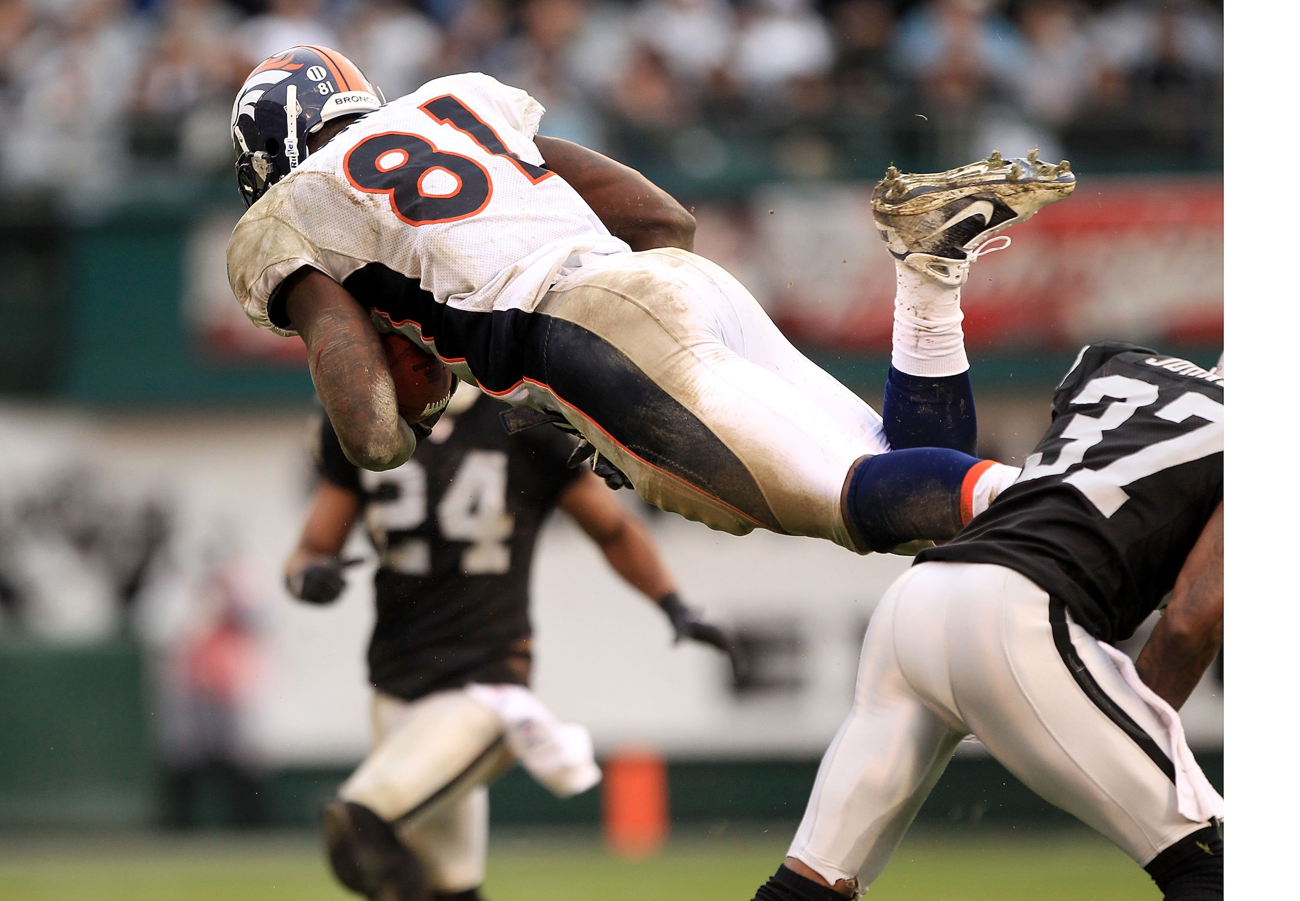 OAKLAND, CA - DECEMBER 19:  Richard Quinn #81 of the Denver Broncos goes airborne after being hit during their game against the Oakland Raiders at Oakland-Alameda County Coliseum on December 19, 2010 in Oakland, California.  (Photo by Ezra Shaw/Getty Imag