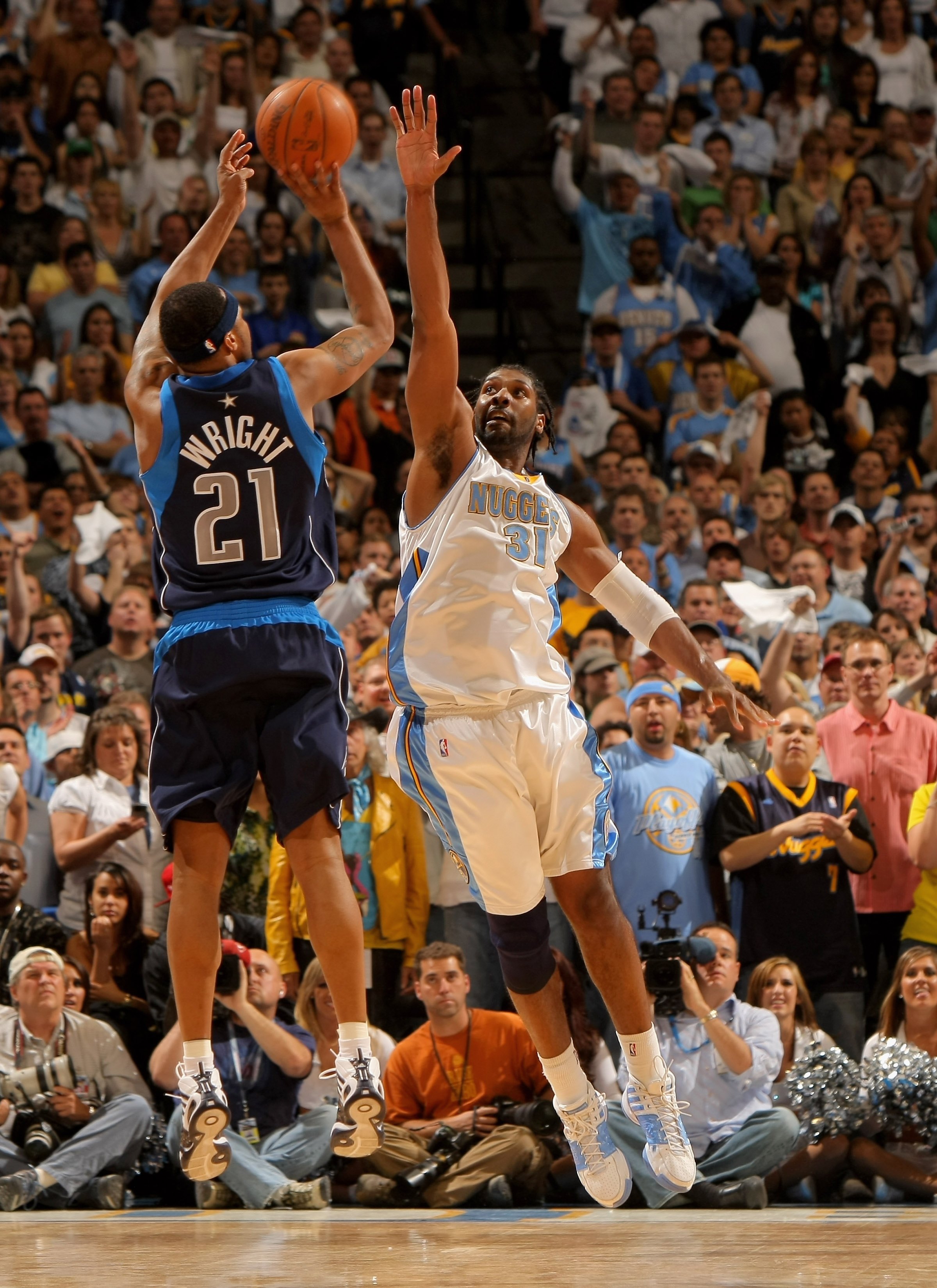DENVER - MAY 13:  Nene #31 of the Denver Nuggets defends against a shot by Antoine Wright #21 of the Dallas Mavericks in Game Five of the Western Conference Semifinals during the 2009 NBA Playoffs at Pepsi Center on May 13, 2009 in Denver, Colorado.  The