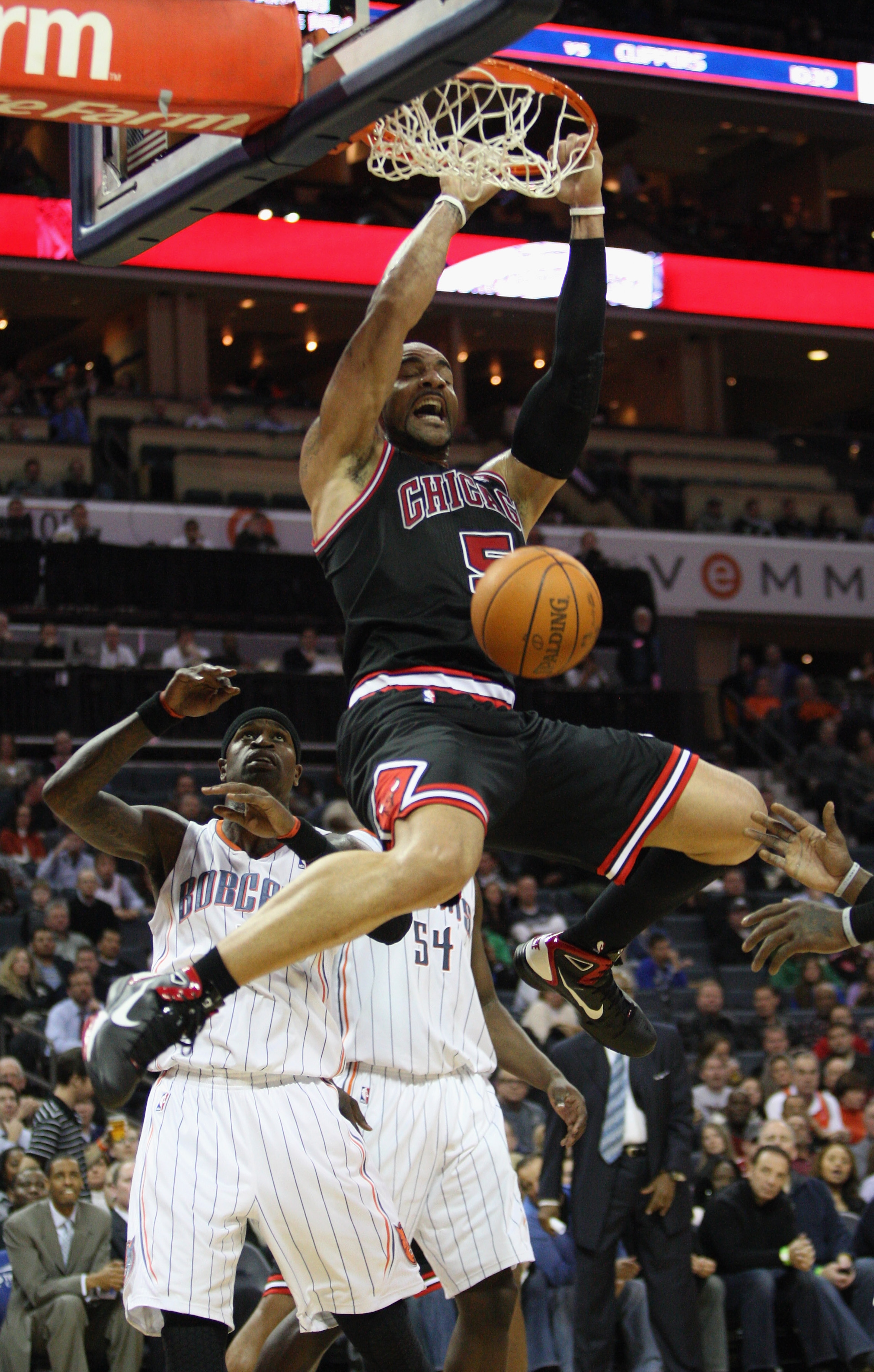 CHARLOTTE, NC - JANUARY 12:  Carlos Boozer #5 of the Chicago Bulls dunks the ball against Stephen Jackson #1 of the Charlotte Bobcats during their game at Time Warner Cable Arena on January 12, 2011 in Charlotte, North Carolina. NOTE TO USER: User express