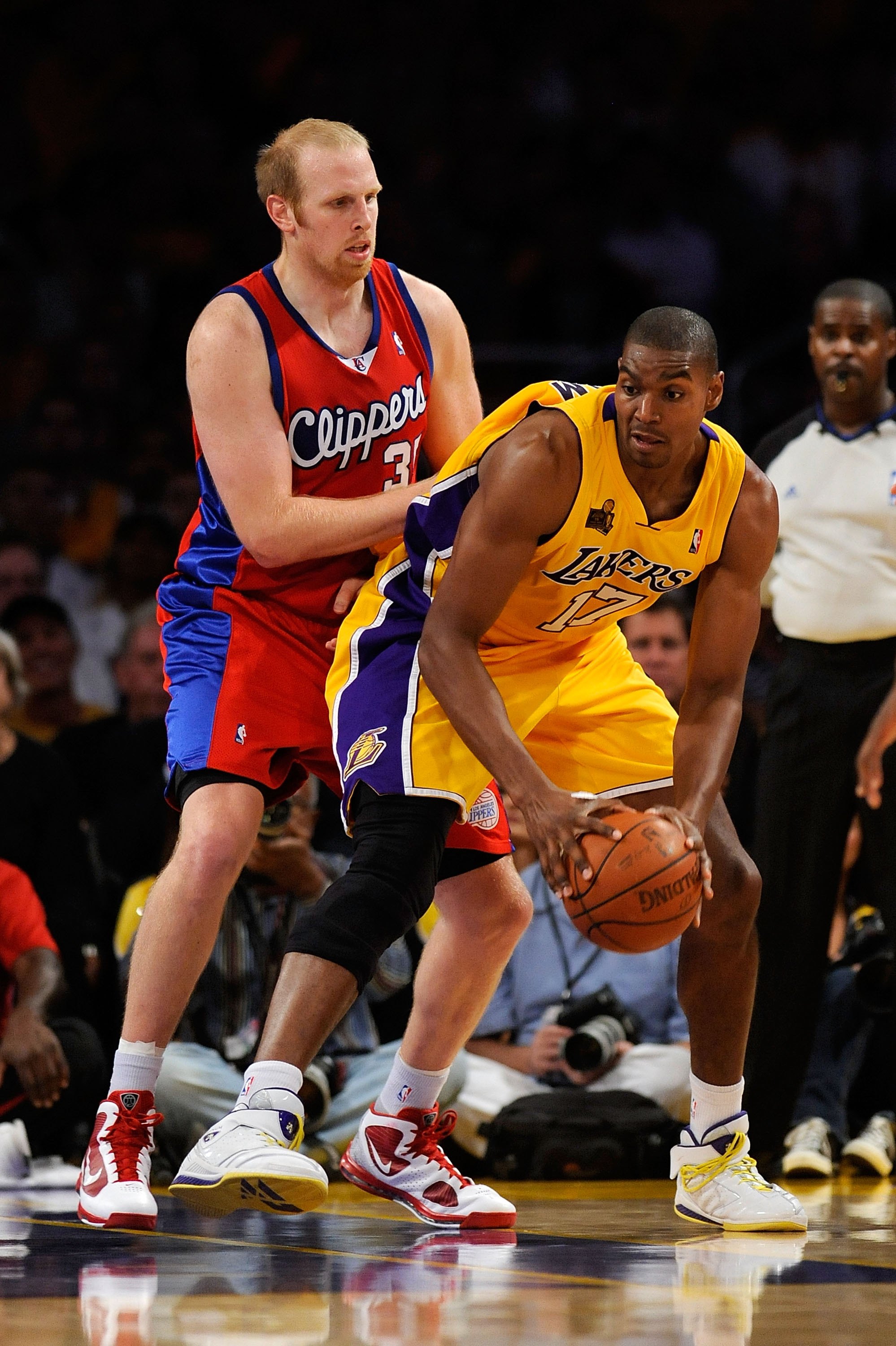 LOS ANGELES, CA - OCTOBER 27:  Andrew Bynum #17 of the Los Angeles Lakers looks to maneuver against Chris Kaman #35 of the Los Angeles Clippers during the season opening game at Staples Center on October 27, 2009 in Los Angeles, California.  The Lakers wo