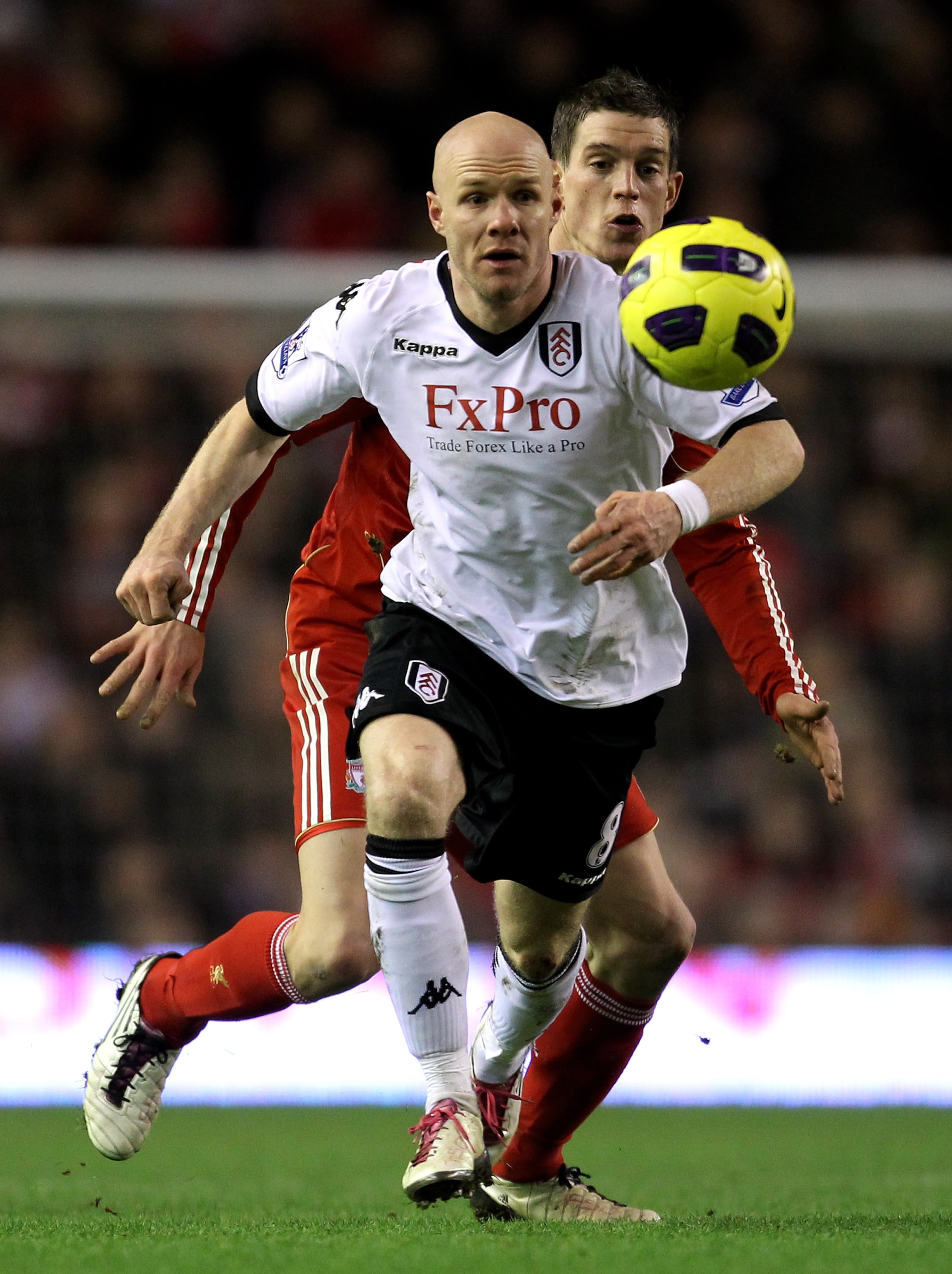 LIVERPOOL, ENGLAND - JANUARY 26:  Andy Johnson of Fulham is challenged by Daniel Agger of Liverpool during the Barclays Premier League match between Liverpool and Fulham at Anfield on January 26, 2011 in Liverpool, England.  (Photo by Alex Livesey/Getty I