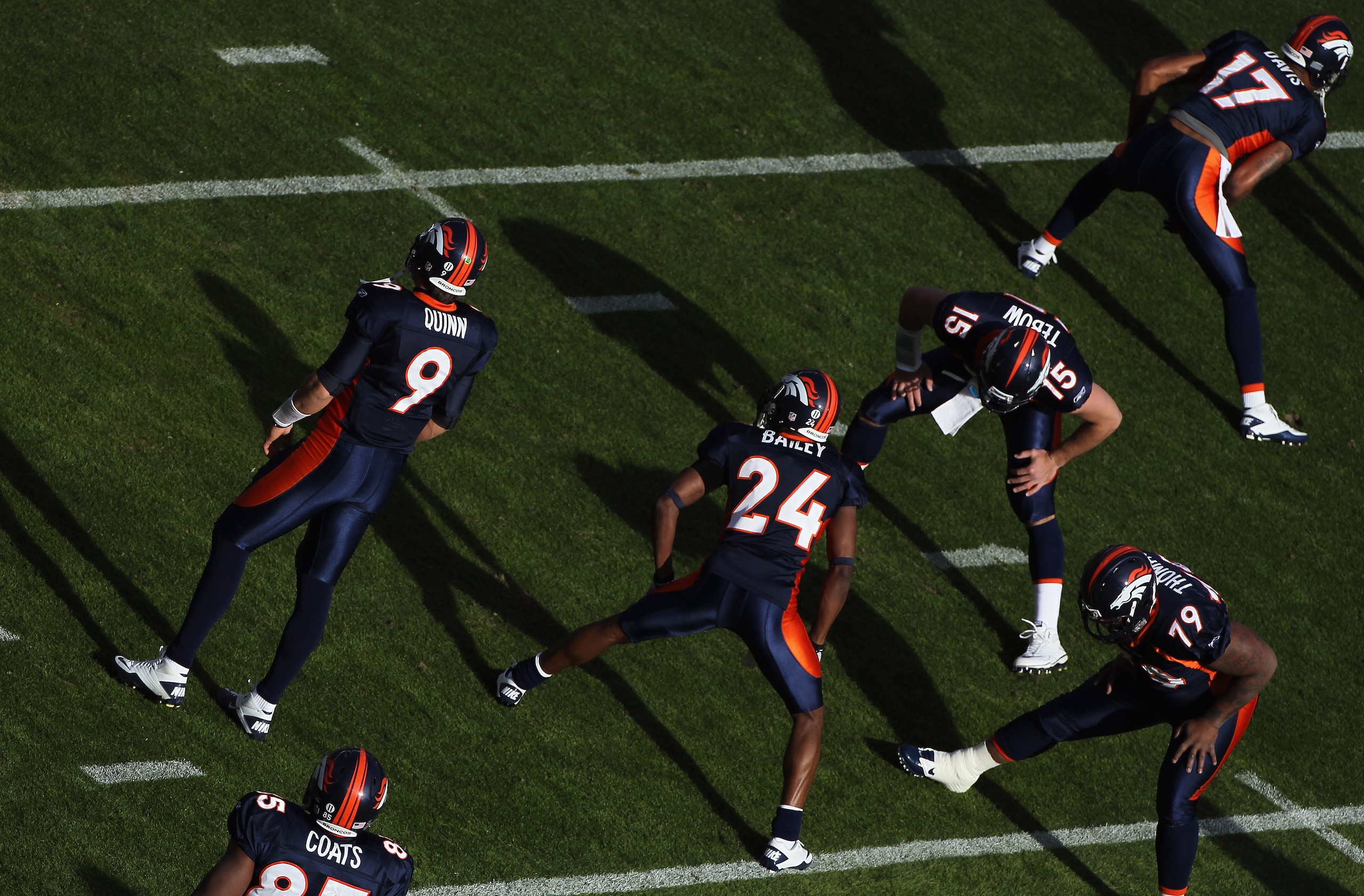 DENVER - DECEMBER 26:  Brady Quinn #9, Daniel Coats #85, Champ Bailey #24, Tim Tebow #15, Marcus Thomas #79, and Britt Davis #17 of the Denver Broncos take the field to warm up prior to facing the Houston Texas at INVESCO Field at Mile High on December 26