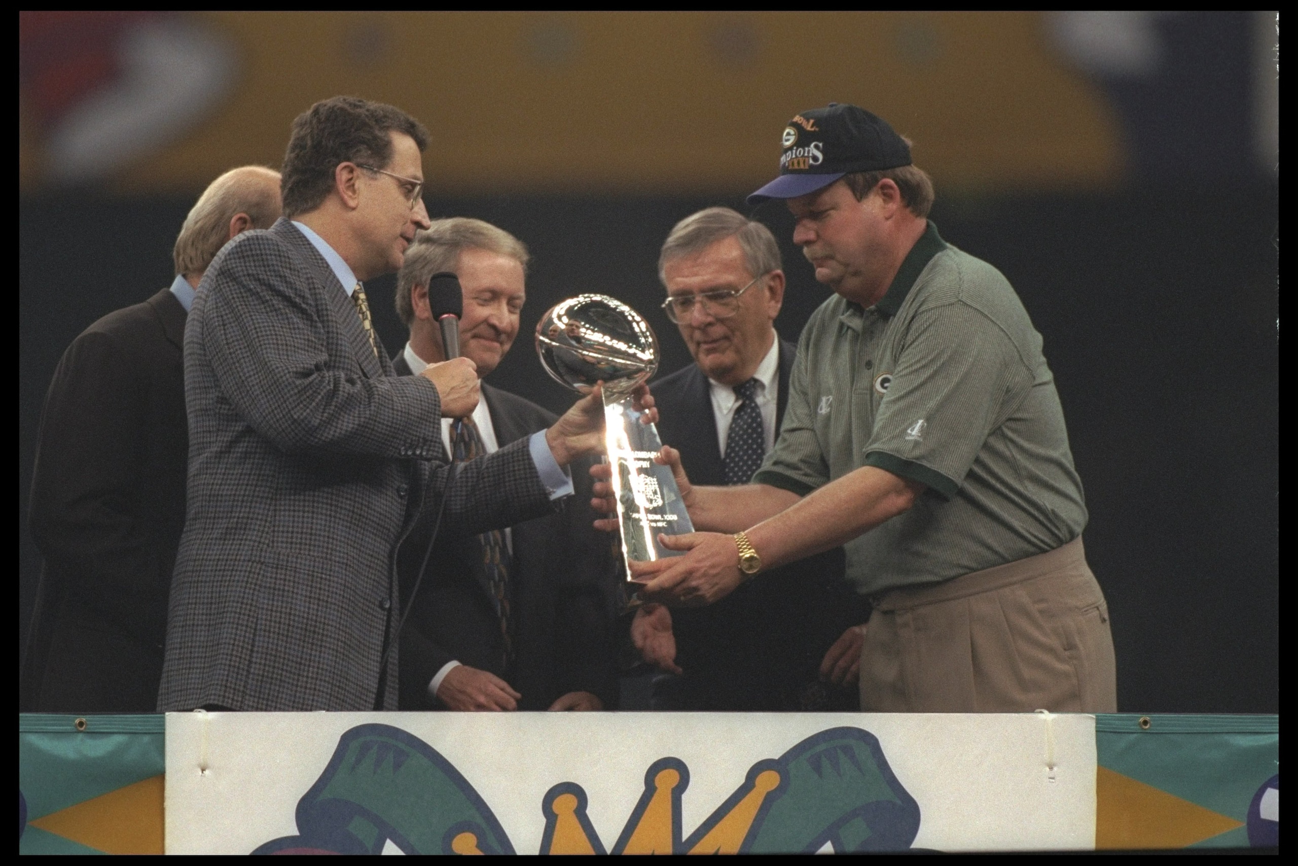 26 Jan 1997:  Head coach Mike Holmgren of the Green Bay Packers (right) receives the Vince Lombardi trophy from NFL commissioner Paul Tagliabue (left) after the Packers beat the New England Patriots 35-21 to win Super Bowl XXXI at the Louisiana Superdome