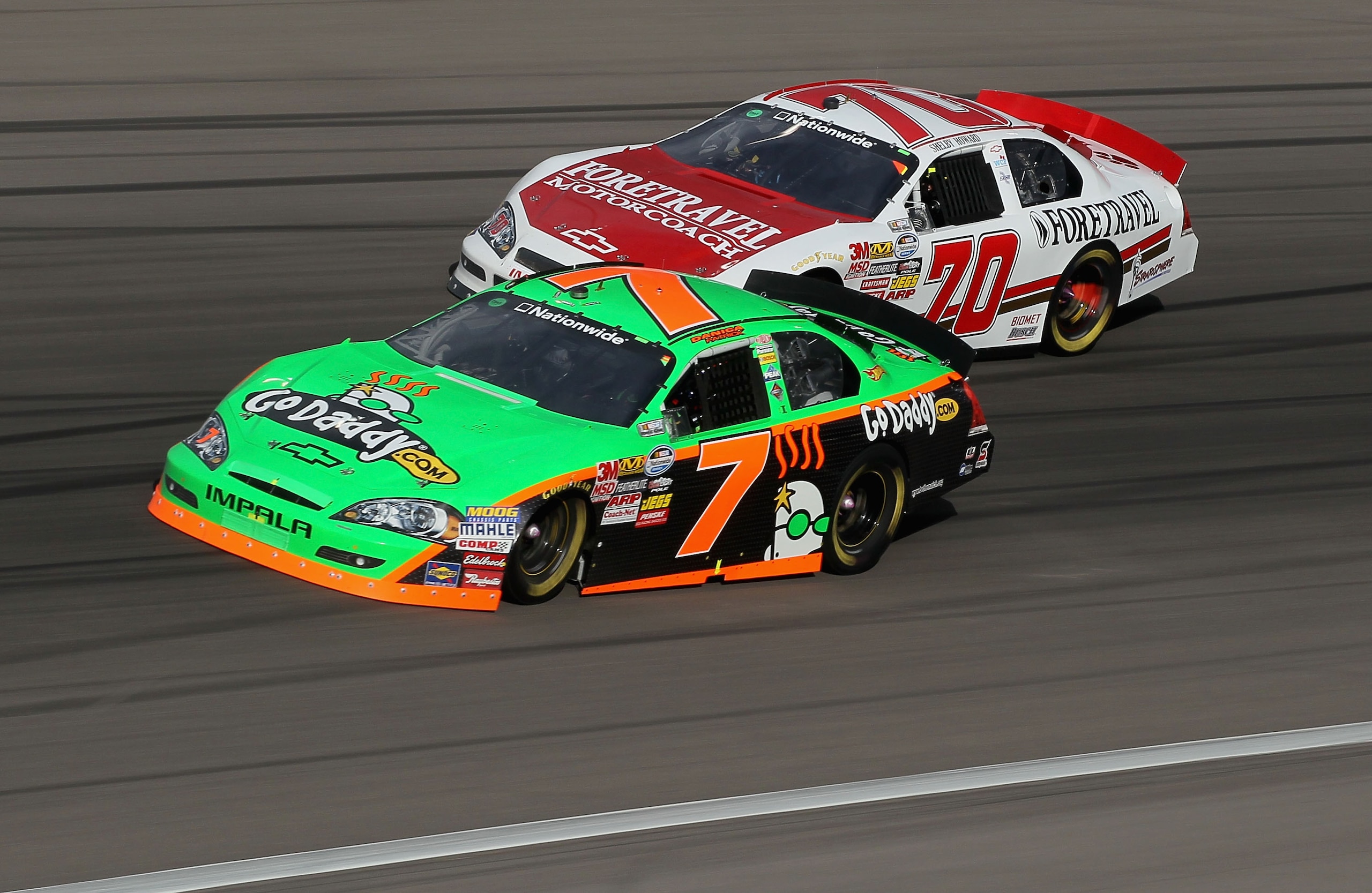 LAS VEGAS - FEBRUARY 27: Danica Patrick, driver of the #7 GoDaddy.com Chevrolet, races Shelby Howard, driver of the #70 ForeTravel Motorcoach Chevrolet, during the NASCAR Nationwide Series Sam's Town 300 at Las Vegas Motor Speedway on February 27, 2010 in