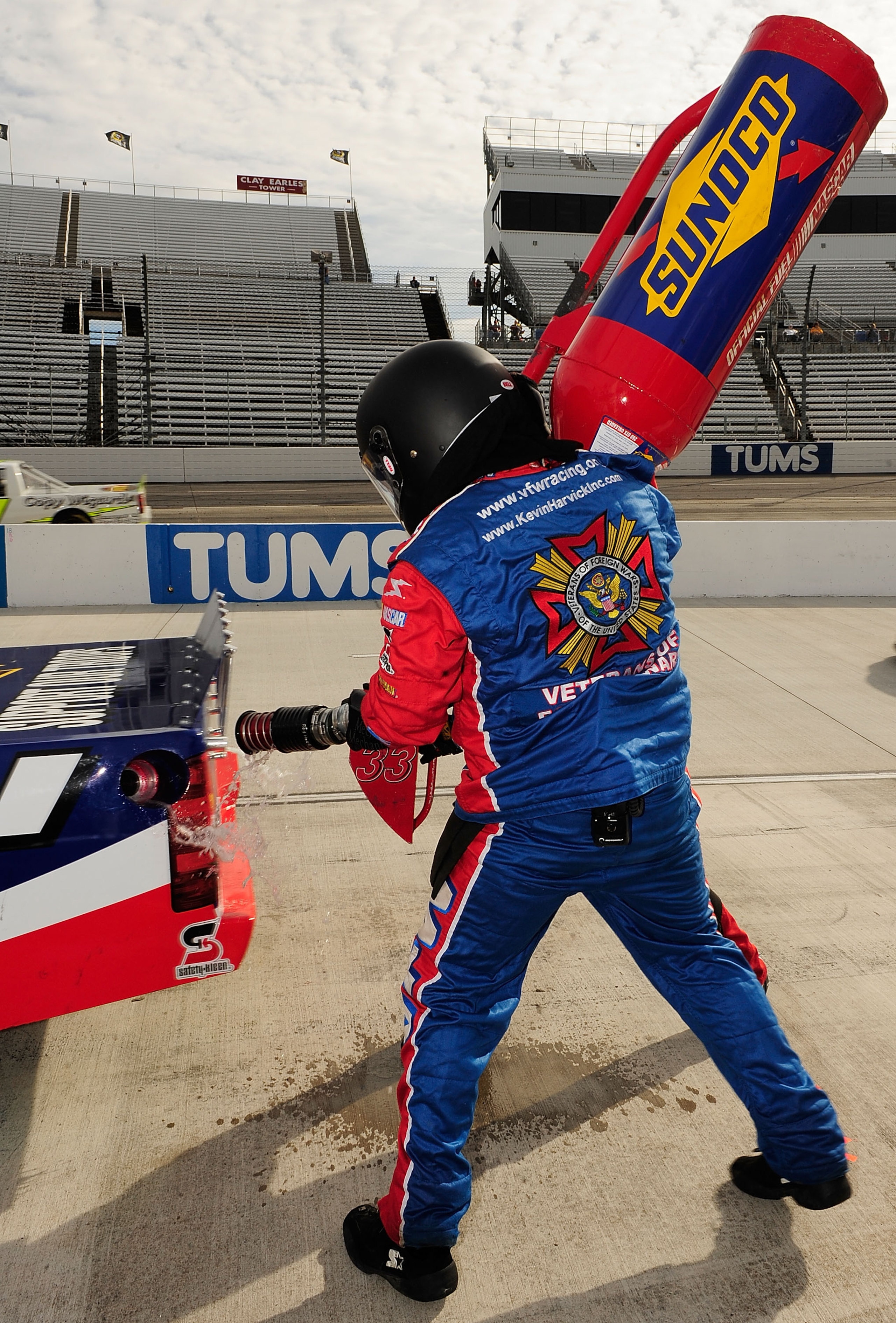 MARTINSVILLE, VA - OCTOBER 24:  The gas man for the #33 VFW Chevrolet, driven by Ron Hornady Jr., disconnects the gas can during pit in the NASCAR Camping World Truck Series Kroger 200 at Martinsville Speedway on October 24, 2009 in Martinsville, Virginia