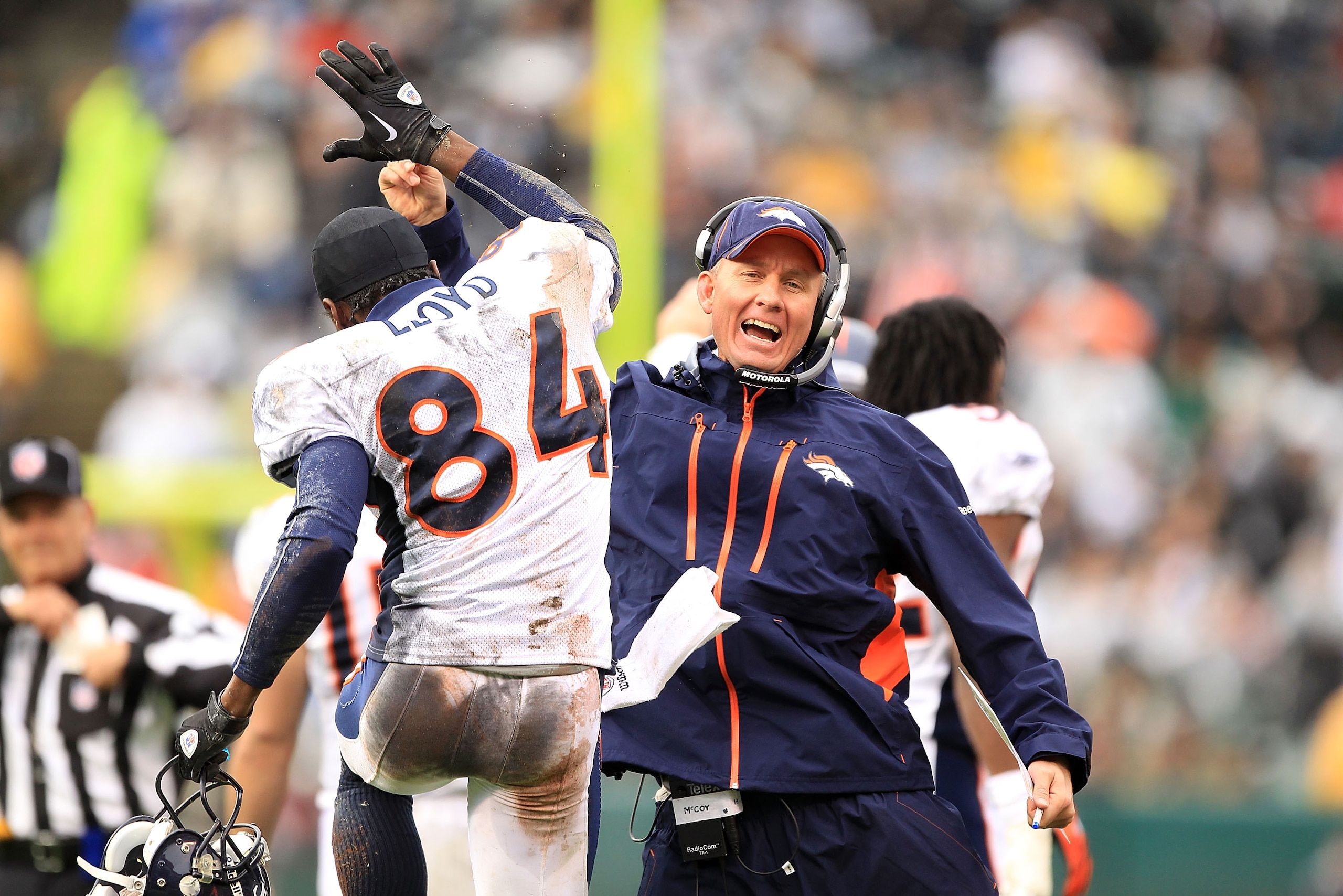 OAKLAND, CA - DECEMBER 19:  Offensive Coordinator Mike McCoy celebrates with Brandon Lloyd #84 of the Denver Broncos after they scored a touchdown against the Oakland Raiders at Oakland-Alameda County Coliseum on December 19, 2010 in Oakland, California.