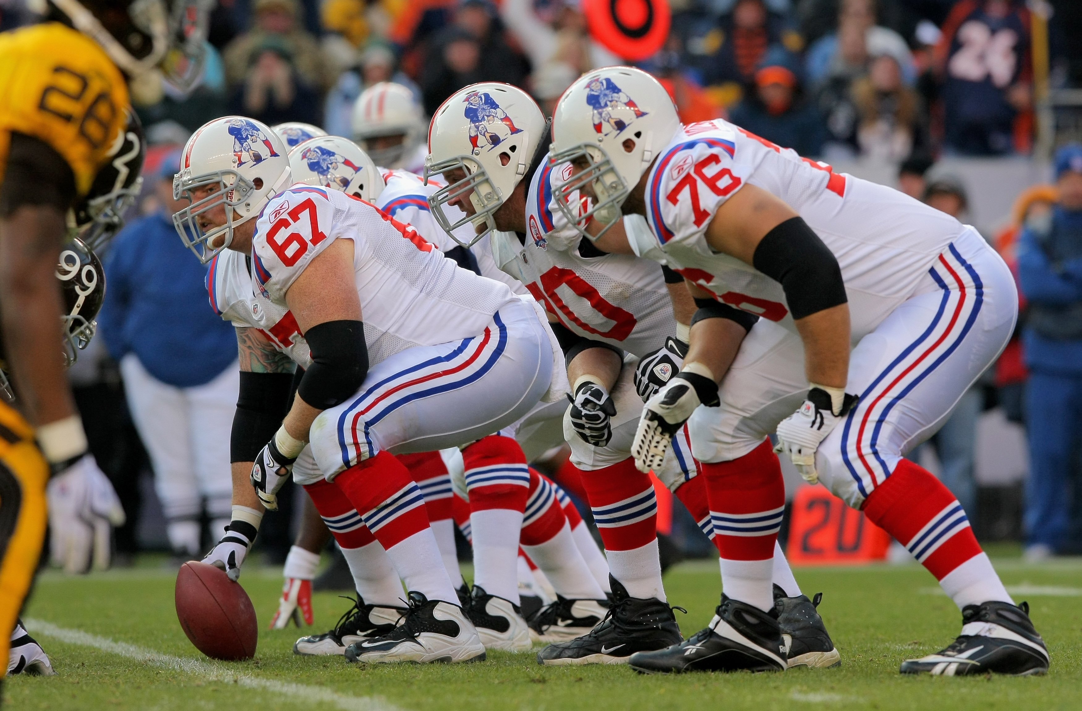 DENVER - OCTOBER 11:  Center Dan Koppen #67 of the New England Patriots prepares to snap the ball as the offensive line readies for pass protection against the Denver Broncos during NFL action at Invesco Field at Mile High on October 11, 2009 in Denver, C