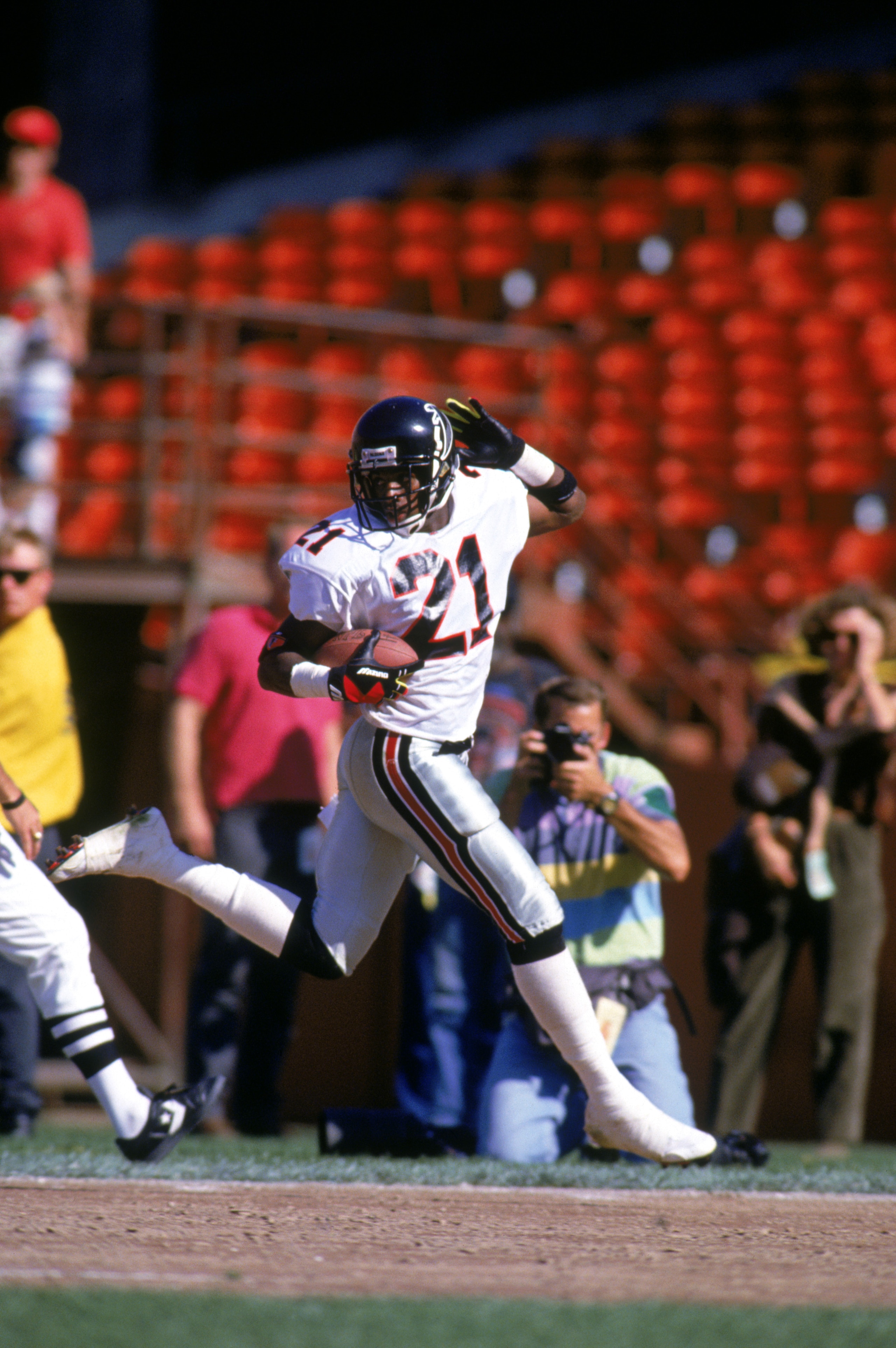 SAN FRANCISCO - OCTOBER 13: Defensive back Deion Sanders #21 of the Atlanta Falcons looks back over his shoulder as he celebrates running the ball against the San Francisco 49ers during a game at Candlestick Park on October 13, 1991 in San Francisco, Cal SAN FRANCISCO - OCTOBER 13: Defensive back Deion Sanders #21 of the Atlanta Falcons looks back over his shoulder as he celebrates running the ball against the San Francisco 49ers during a game at Candlestick Park on October 13, 1991 in San Francisco, Cal