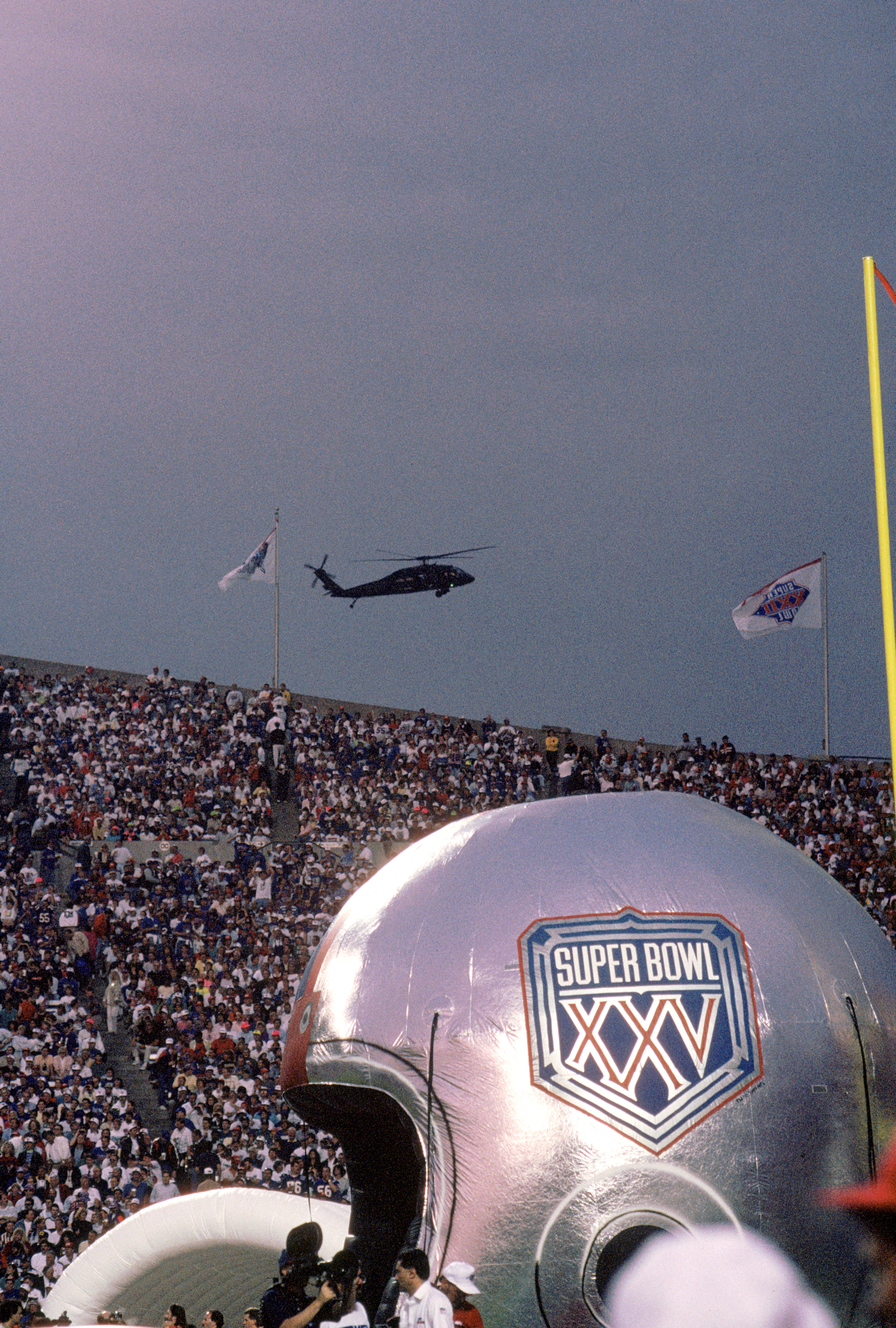 TAMPA, FL - JANUARY 27:  General view of the Super Bowl XXV logo on an inflatable helmet as a military helicopter patrols the air space above Tampa Stadium looking for terrorist prior to Super Bowl XXV between the Buffalo Bills and the New York Giants at