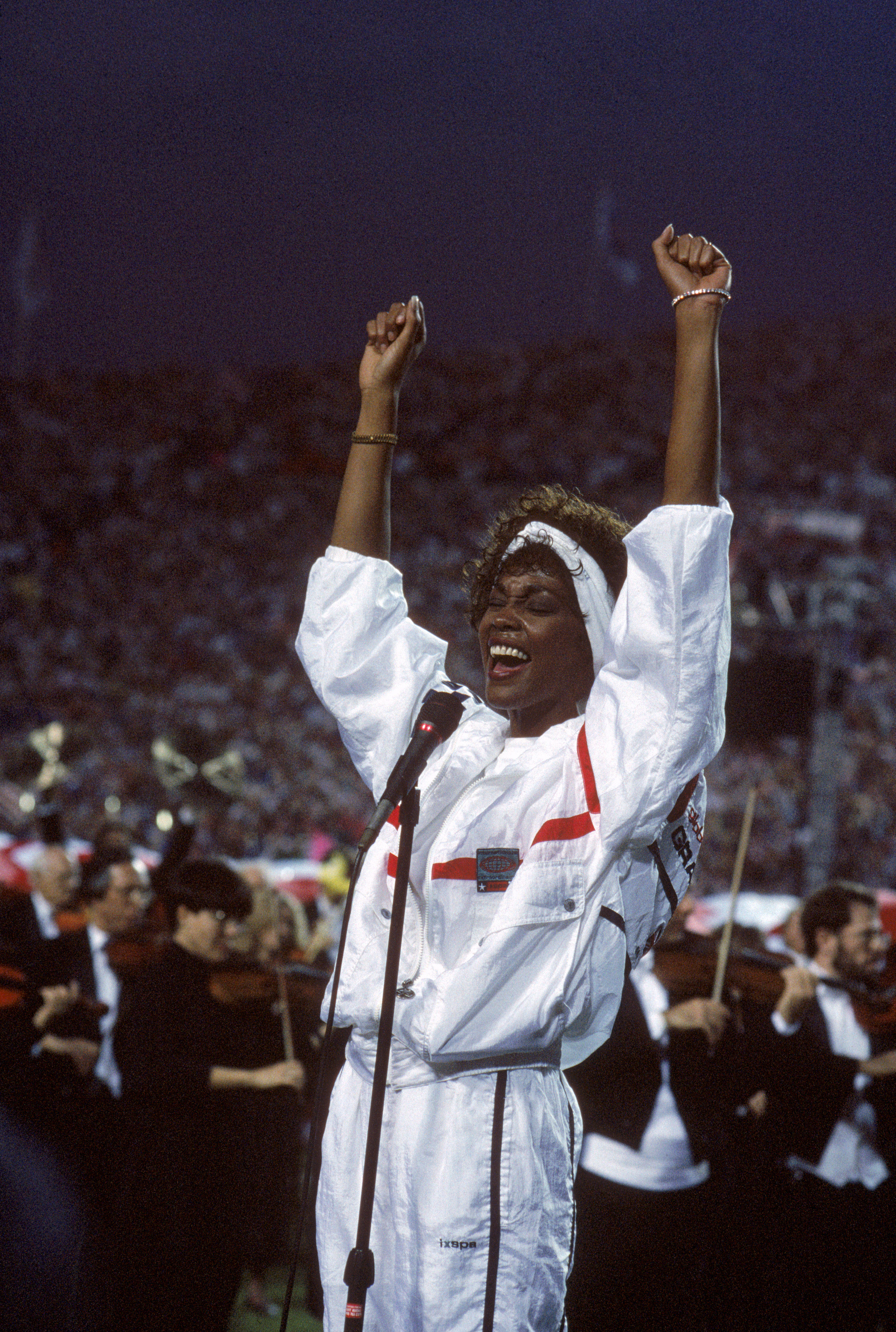 TAMPA, FL - JANUARY 27:  Whitney Houston sings the National Anthem before a game with the New York Giants taking on the Buffalo Bills prior to Super Bowl XXV at Tampa Stadium on January 27, 1991 in Tampa, Florida. The Giants won 20-19. (Photo by George Ro