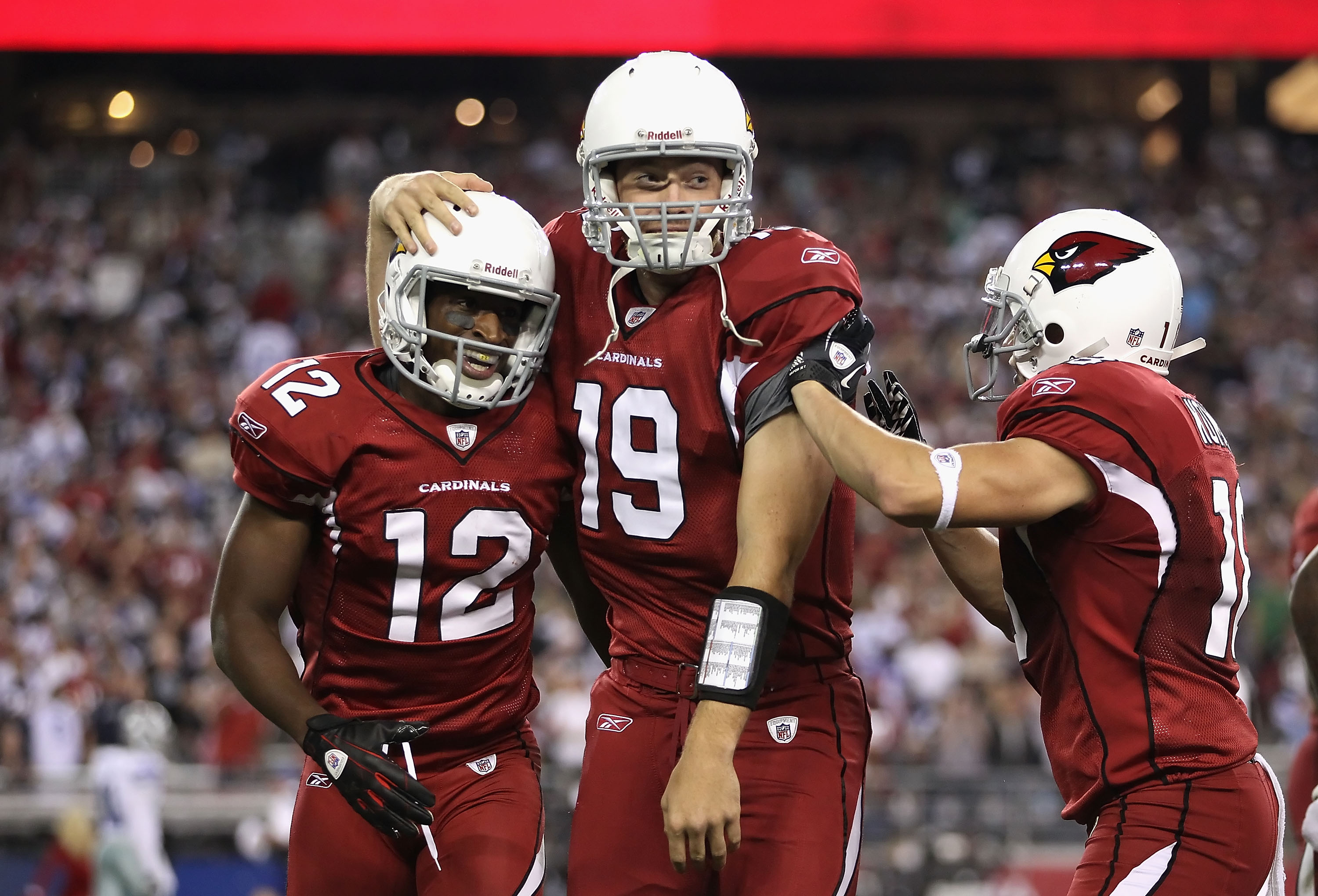 GLENDALE, AZ - DECEMBER 25: Wide receiver Andre Roberts #12 of the Arizona Cardinals celebrates with quarterback John Skelton #19 after scoring on a 74 yard touchdown reception against the Dallas Cowboys during the second quarter of the NFL game at the Un