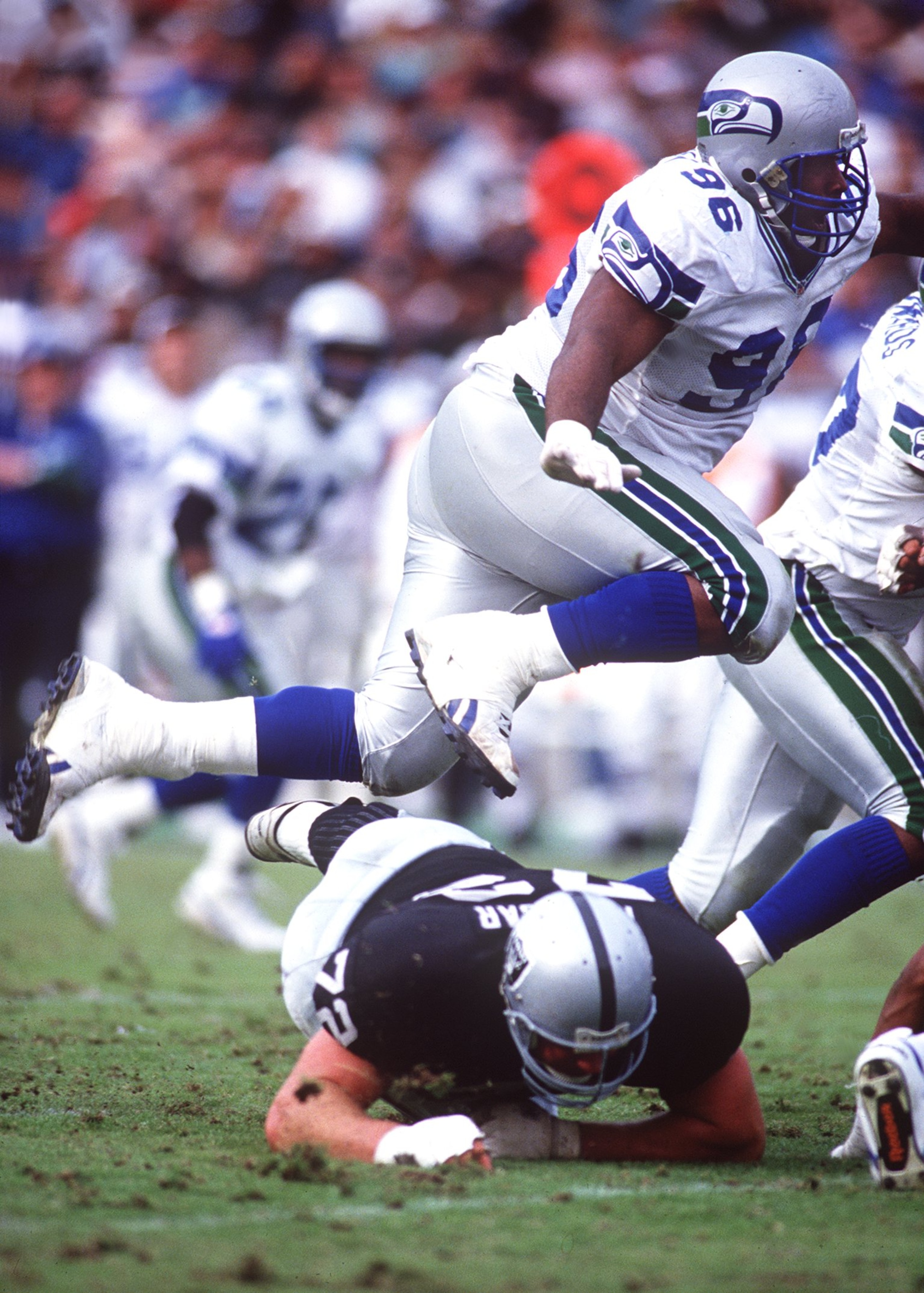12 Dec 1993: SEATTLE DEFENSIVE TACKLE CORTEZ KENNEDY HURDLES LOS ANGLELES OFFENSIVE LINEMAN DON MOSEBAR DURING THE SEAHAWKS 27-23 LOSS TO THE RAIDERS AT THE LOS ANGELES MEMORIAL COLISEUM. 12 Dec 1993: SEATTLE DEFENSIVE TACKLE CORTEZ KENNEDY HURDLES LOS ANGLELES OFFENSIVE LINEMAN DON MOSEBAR DURING THE SEAHAWKS 27-23 LOSS TO THE RAIDERS AT THE LOS ANGELES MEMORIAL COLISEUM.