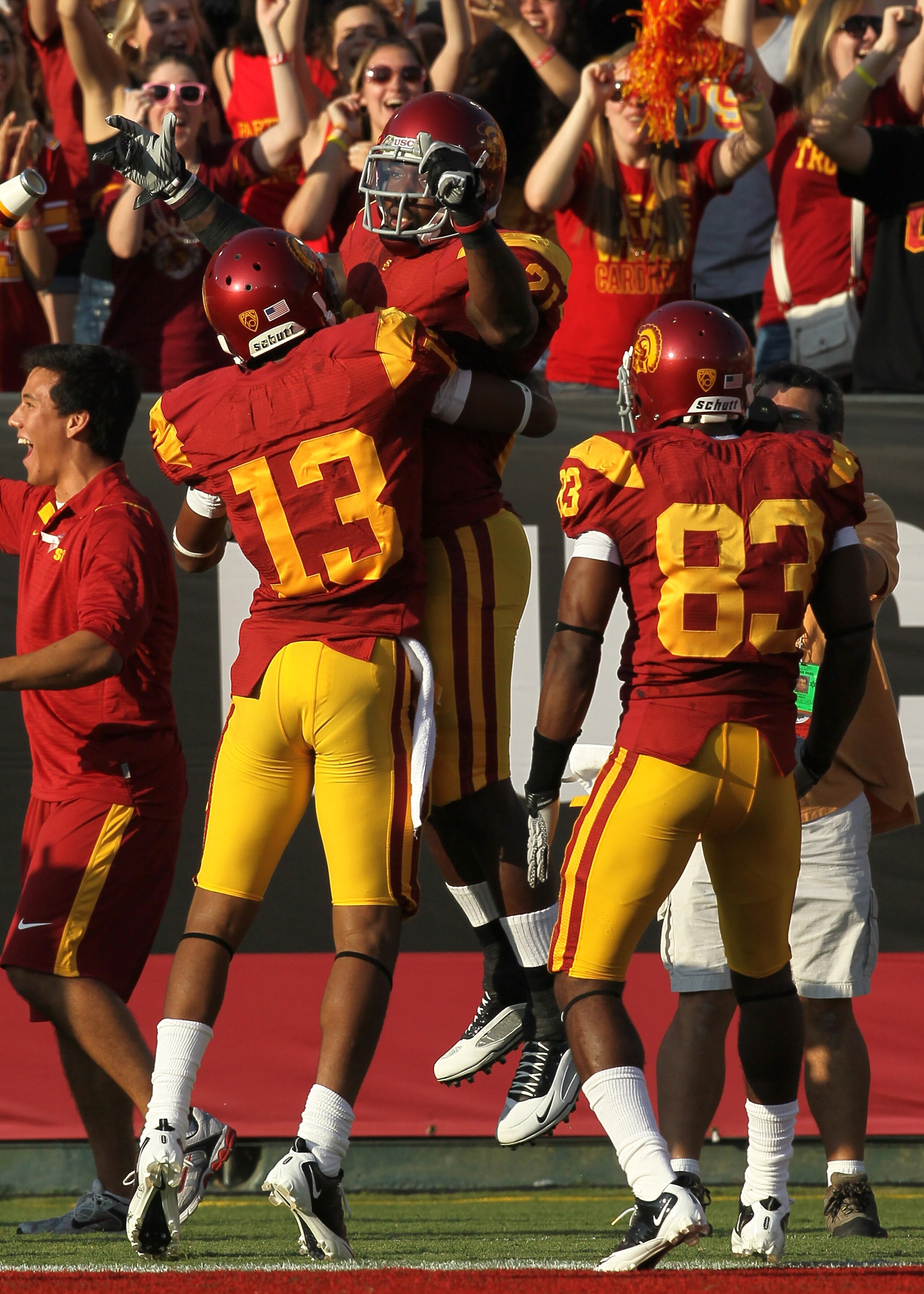 LOS ANGELES - OCTOBER 2:  Running back Allen Bradford #21 of the USC Trojans celebrates his 37 yard touchdown run in the first quarter against the Washington Huskies with teammates Robert Woods #13 and Ronald Johnson #83 at the Los Angeles Memorial Colise