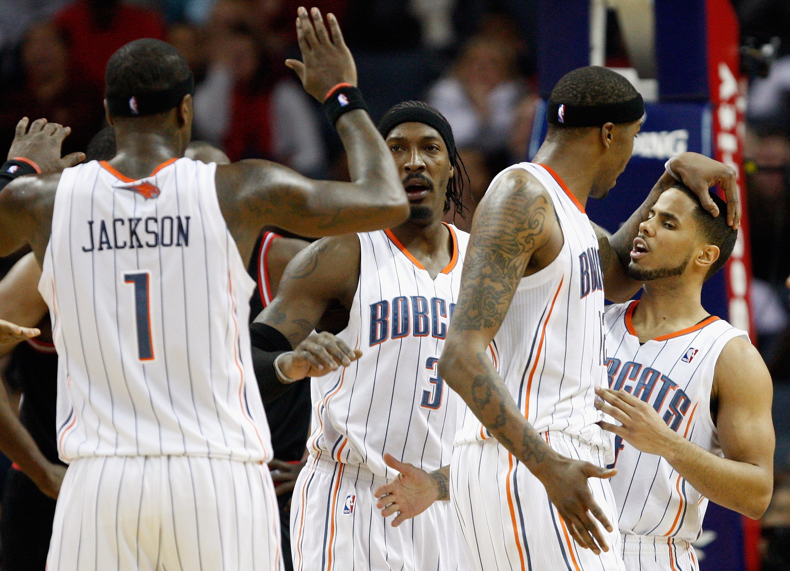 CHARLOTTE, NC - JANUARY 12:  Teammates Stephen Jackson #1 Gerald Wallace #3 Tyrus Thomas #12 and D.J. Augustin #14 of the Charlotte Bobcats celebrate after a basket against the Chicago Bulls during their game at Time Warner Cable Arena on January 12, 2011