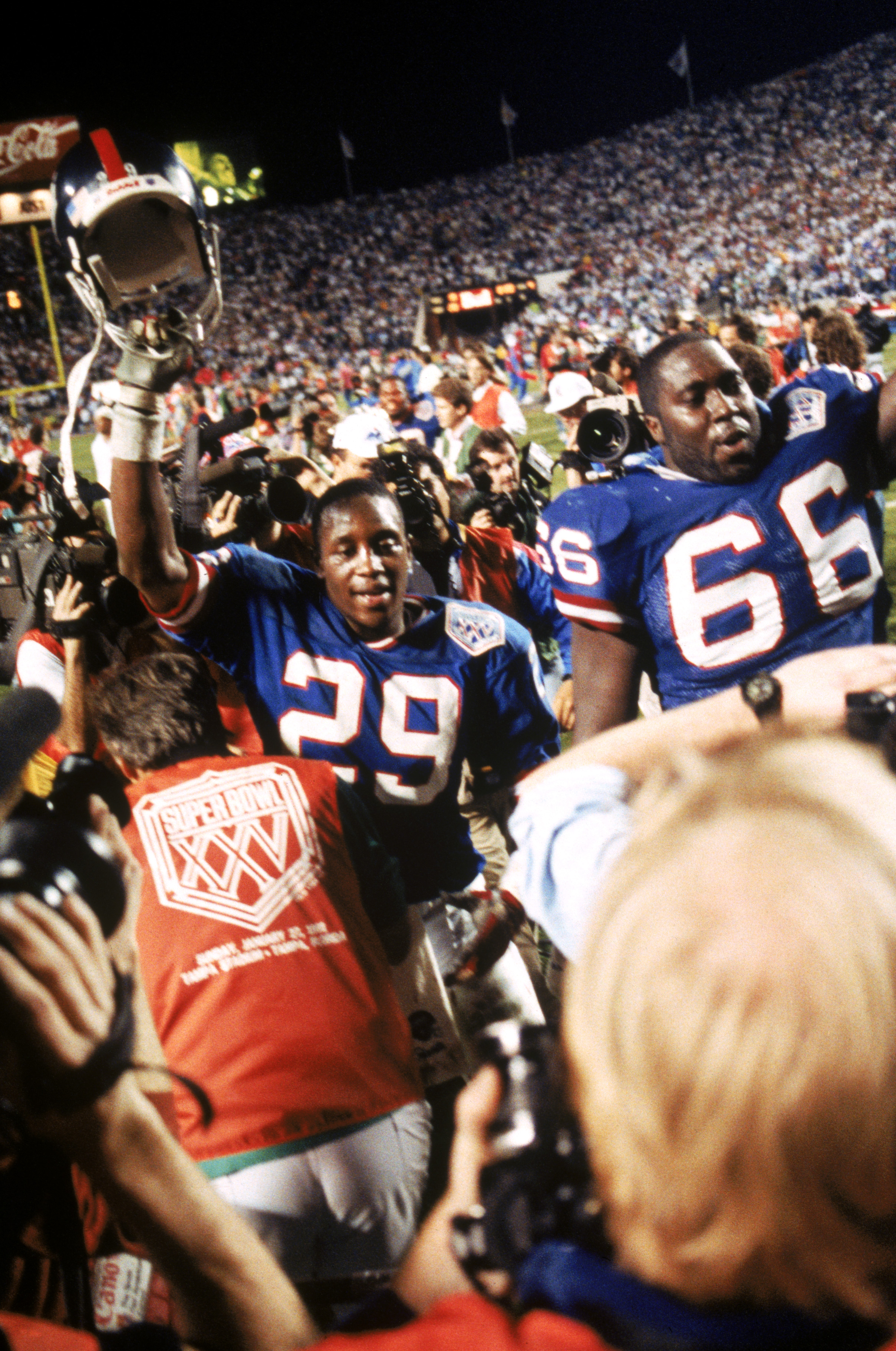TAMPA, FL - JANUARY 27:  Safety Myron Guyton #29 and offensive tackle William Roberts #66 of the New York Giants walk off the field following the game against the Buffalo Bills during Super Bowl XXV at Tampa Stadium on January 27, 1991 in Tampa, Florida.