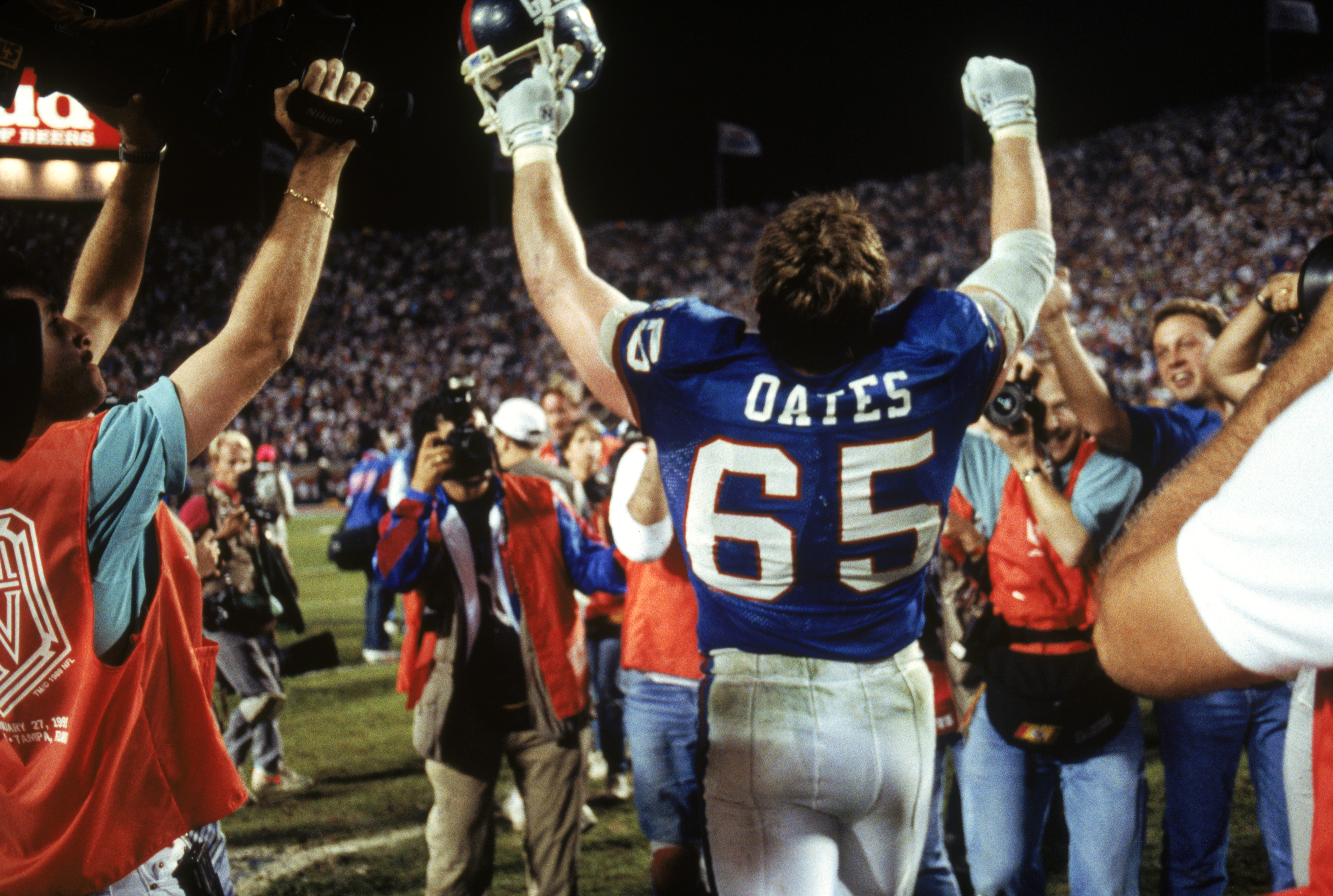 TAMPA, FL - JANUARY 27:  Center Bart Oates #65 of the New York Giants celebrates following the game against the Buffalo Bills during Super Bowl XXV at Tampa Stadium on January 27, 1991 in Tampa, Florida. The Giants defeated the Bills 20-19.  (Photo by Geo