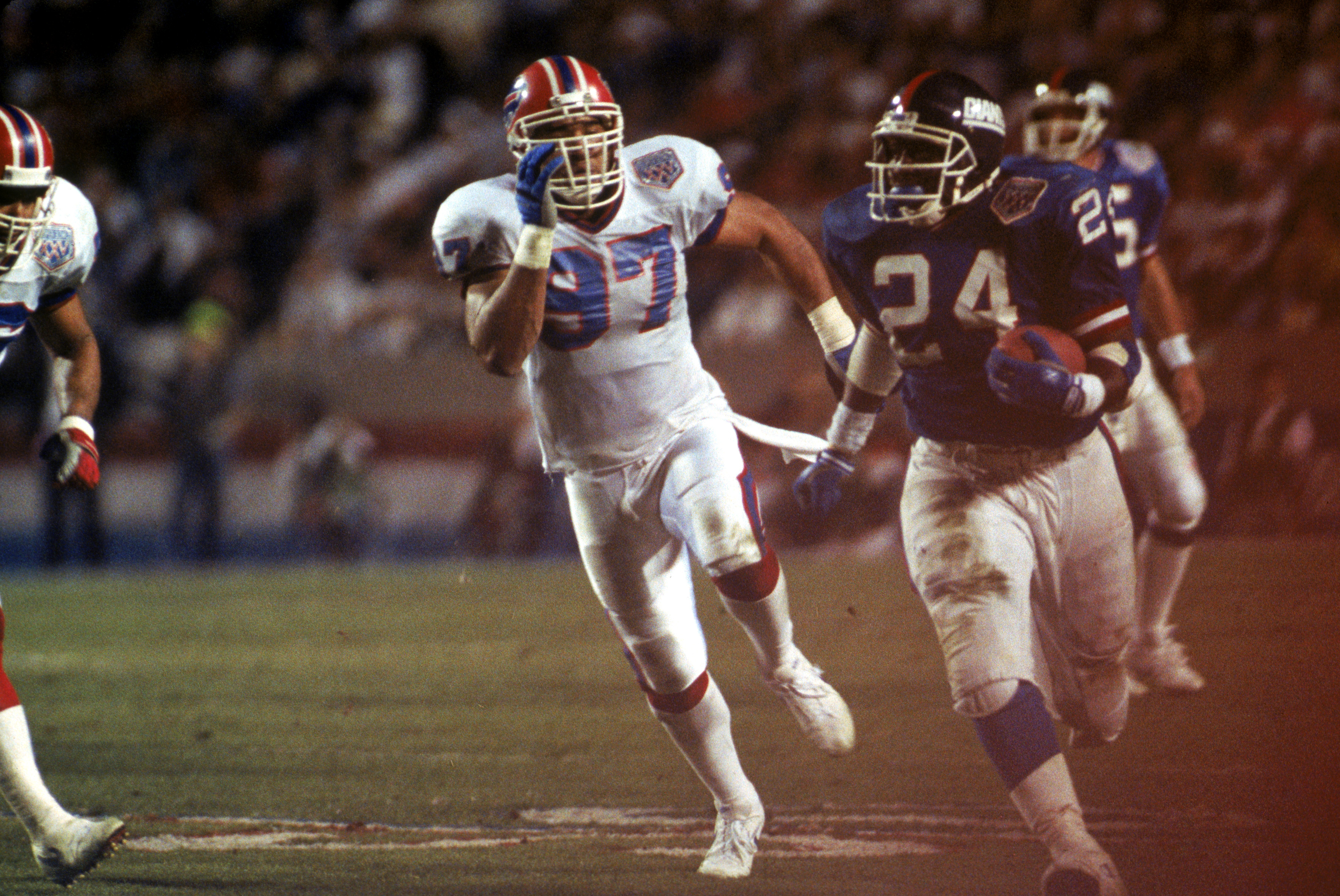 TAMPA, FL - JANUARY 27:  Running back Ottis Anderson #24 of the New York Giants carries the ball against linebacker Cornelius Bennett #97 of the Buffalo Bills during Super Bowl XXV at Tampa Stadium on January 27, 1991 in Tampa, Florida. The Giants defeate