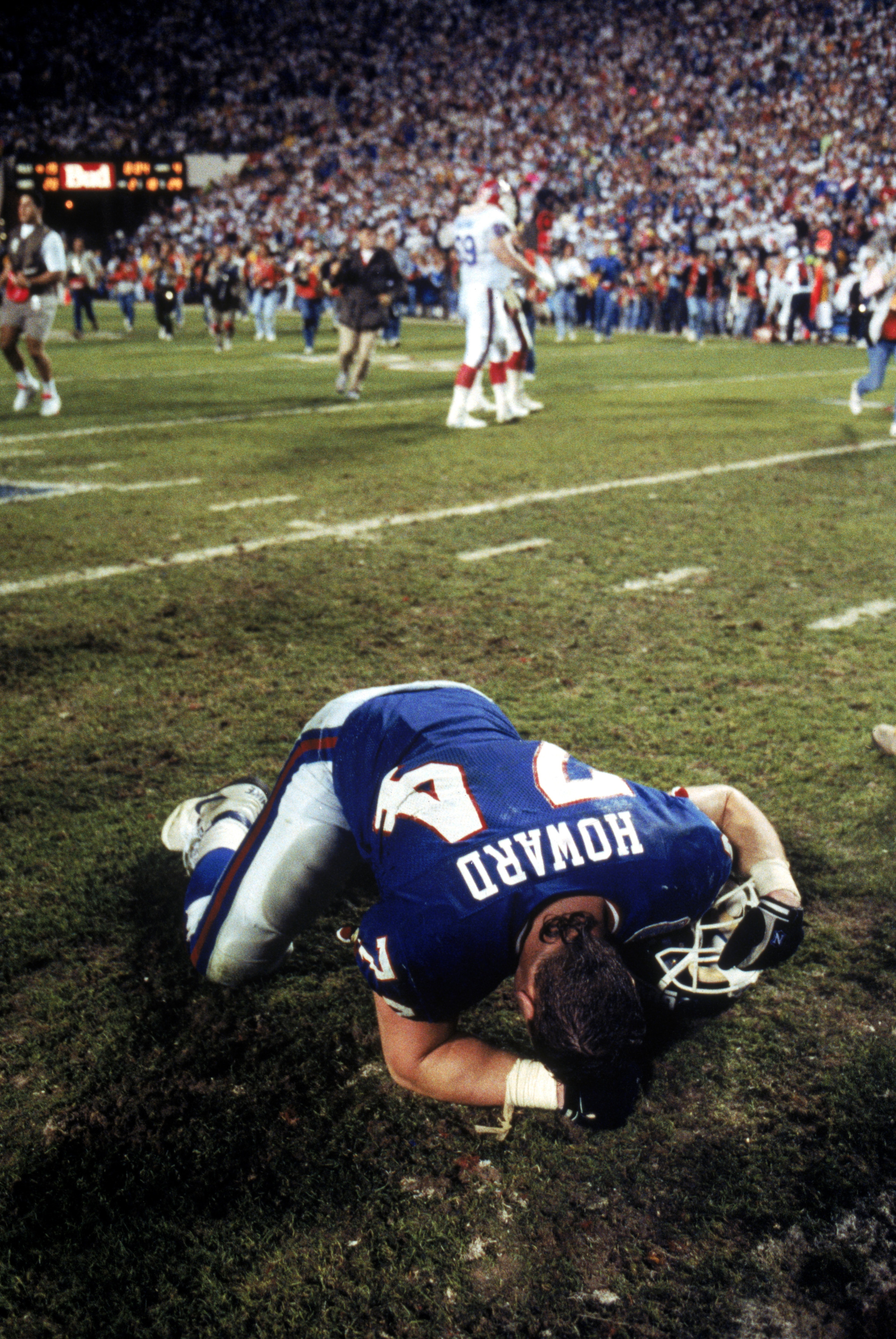 TAMPA, FL - JANUARY 27:  Defensive lineman Erik Howard #74 of the New York Giants collapses on the field following the game against the Buffalo Bills during Super Bowl XXV at Tampa Stadium on January 27, 1991 in Tampa, Florida. The Giants defeated the Bil