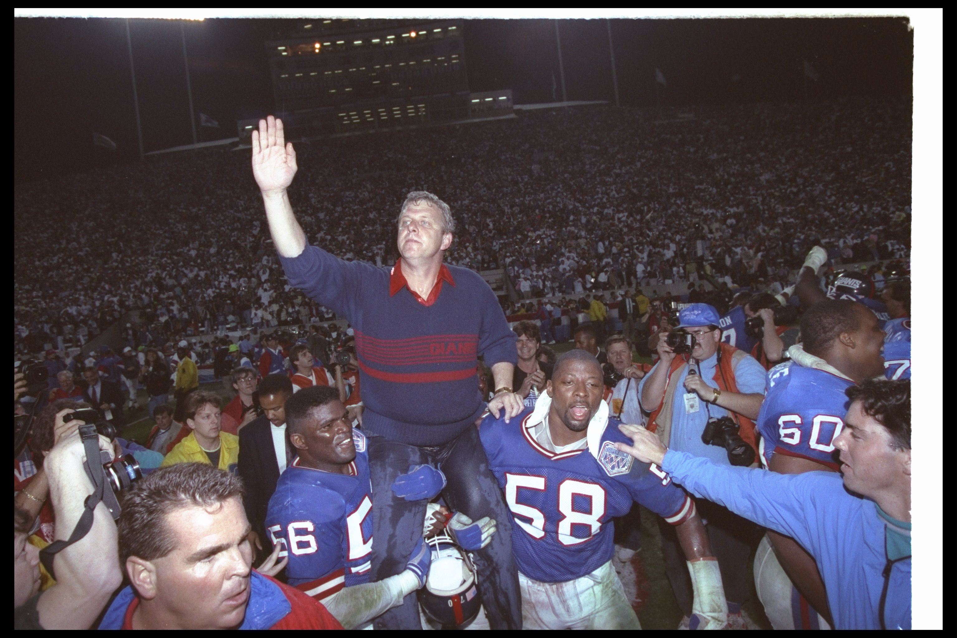 12 Jan 1991: New York Giants head coach Bill Parcells is paraded around on the shoulders of players Lawrence Taylor #56 and Carl Banks #58 after winning Super Bowl XXV against the Buffalo Bills at Tampa Stadium in Tampa, Florida. The Giants won the game,