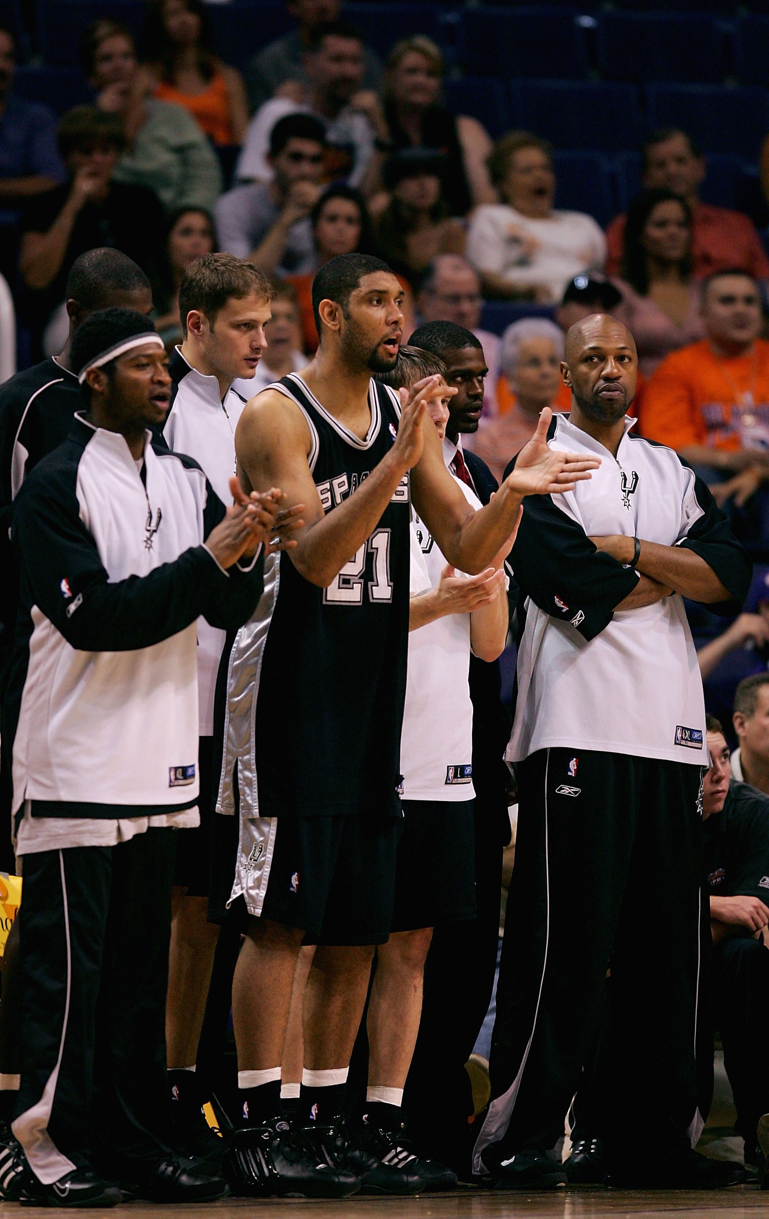 PHOENIX - MAY 22: (L-R)Devin Brown #23, Tim Duncan #21 and Tony Massenburg #34 of the San Antonio Spurs cheer from the sidelines as their team leads the Phoenix Suns in Game one of the Western Conference Finals during the 2005 NBA Playoffs at America Wes PHOENIX - MAY 22: (L-R)Devin Brown #23, Tim Duncan #21 and Tony Massenburg #34 of the San Antonio Spurs cheer from the sidelines as their team leads the Phoenix Suns in Game one of the Western Conference Finals during the 2005 NBA Playoffs at America Wes