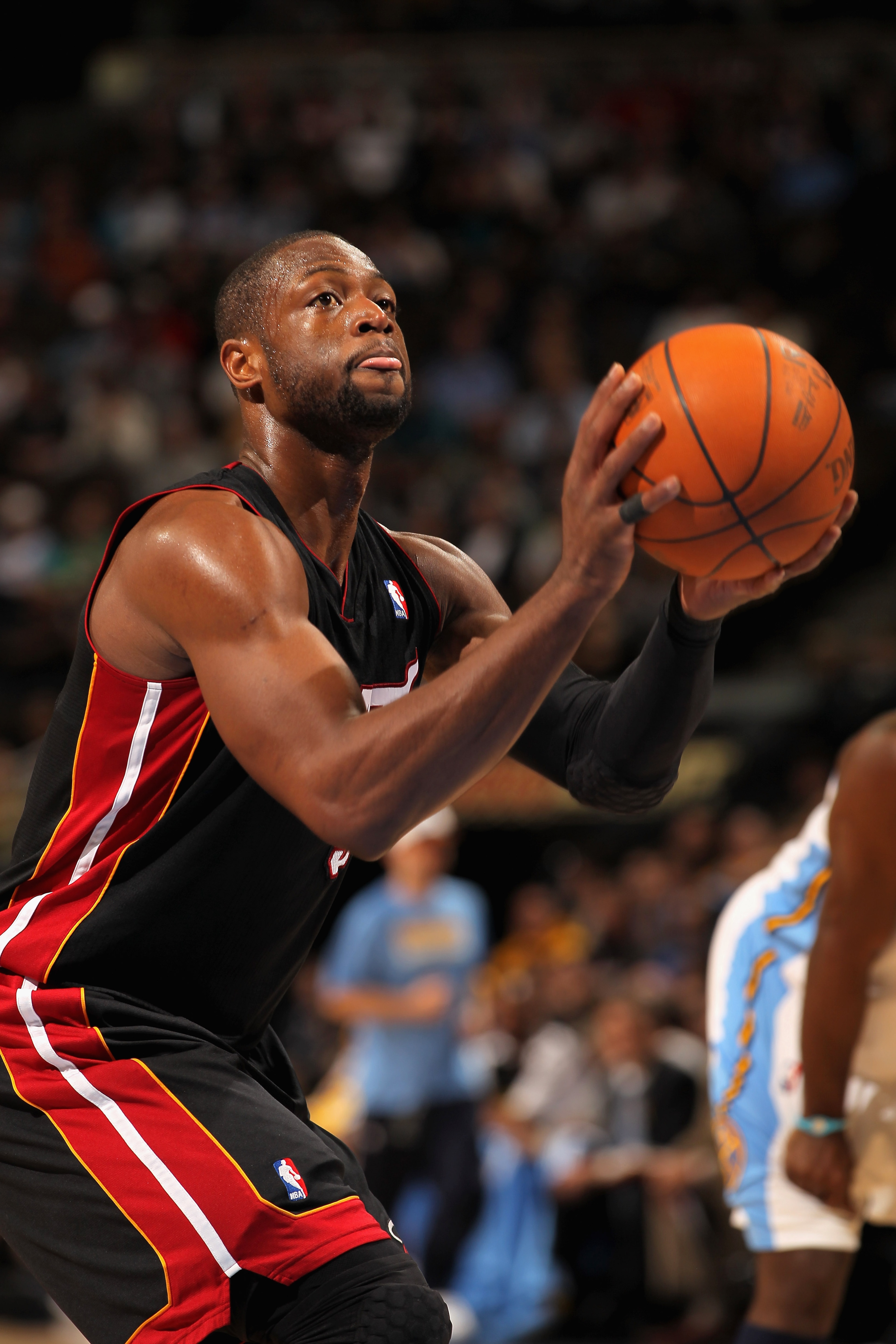 DENVER, CO - JANUARY 13:  Dwayne Wade #3 of the Miami Heat takes a free throw against the Denver Nuggets at the Pepsi Center on January 13, 2011 in Denver, Colorado. The Nuggets defeated the Heat 130-102. NOTE TO USER: User expressly acknowledges and agre
