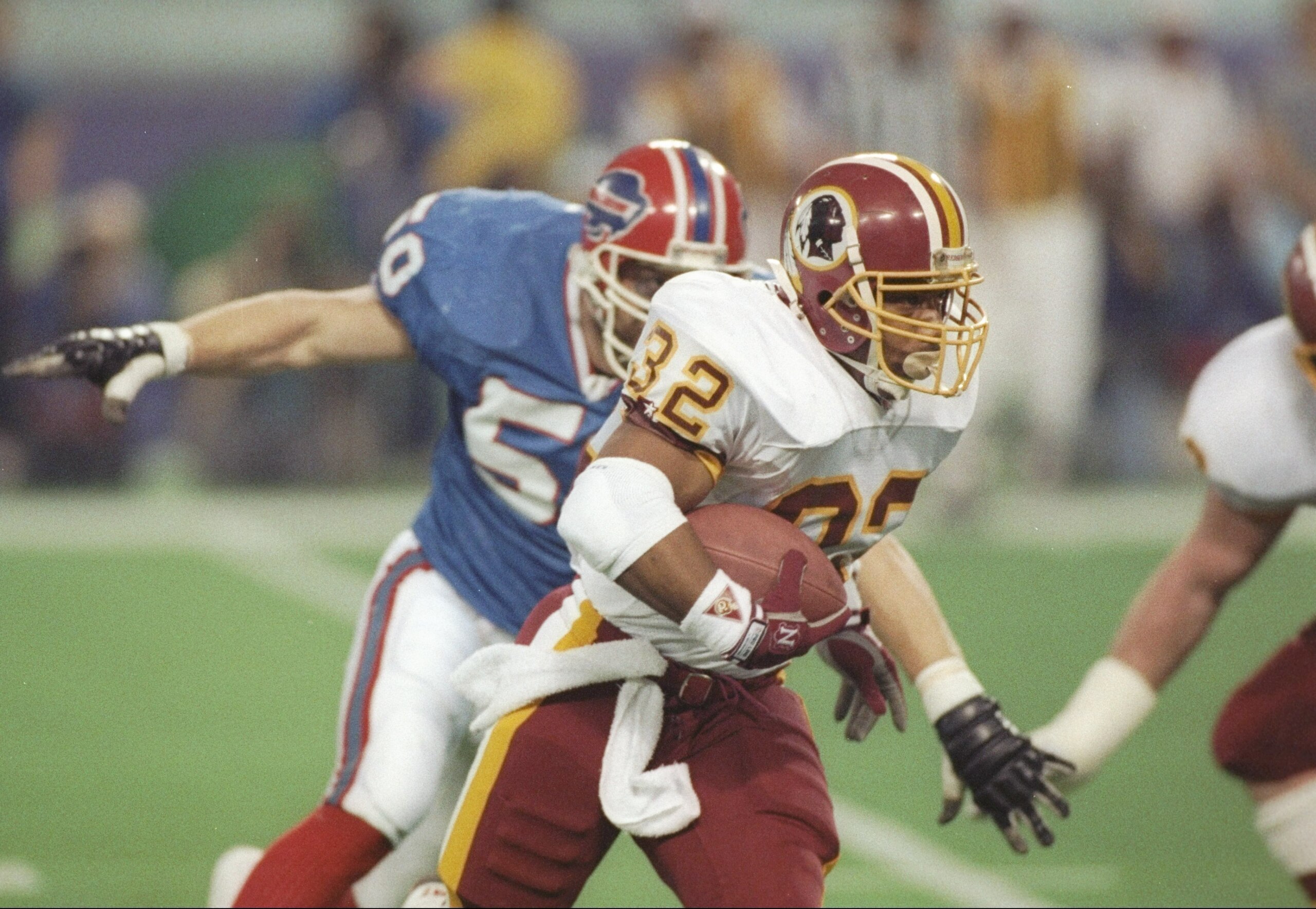 26 Jan 1992:  Running back Ricky Ervins # 32 of the Washington Redskins carries the ball downfield during Super Bowl XXVI against the Buffalo Bills at Humpert H. Humphrey Metrodome in Minneapolis, Minnesota.  The Redskins won 37-24. Mandatory Credit: Rick