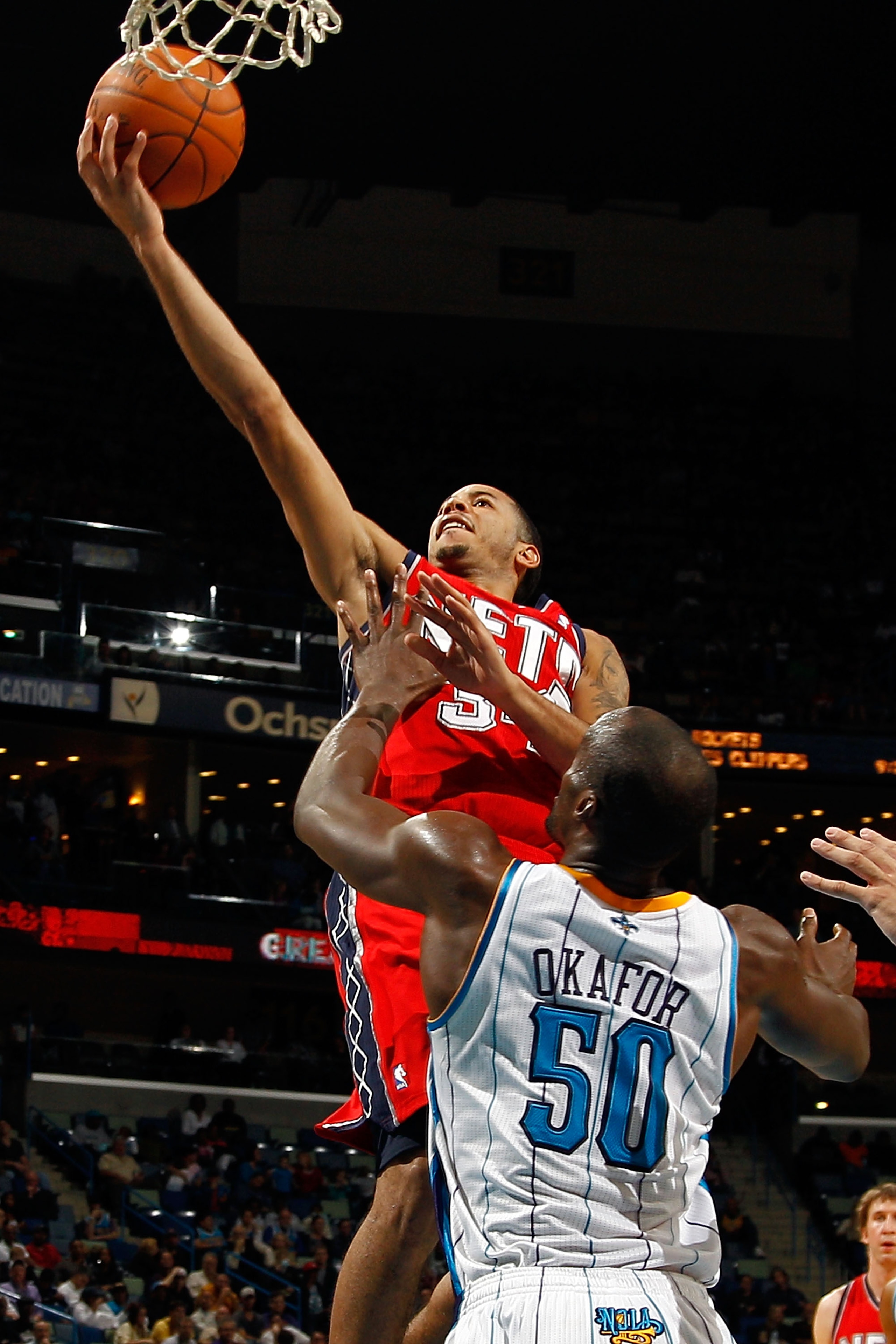 NEW ORLEANS, LA - DECEMBER 22:  Devin Harris #34 of the New Jersey Nets shoots the ball over Emeka Okafor #50 of the New Orleans Hornets at the New Orleans Arena on December 22, 2010 in New Orleans, Louisiana.    The Hornets defeated the Nets 105-91.   NO
