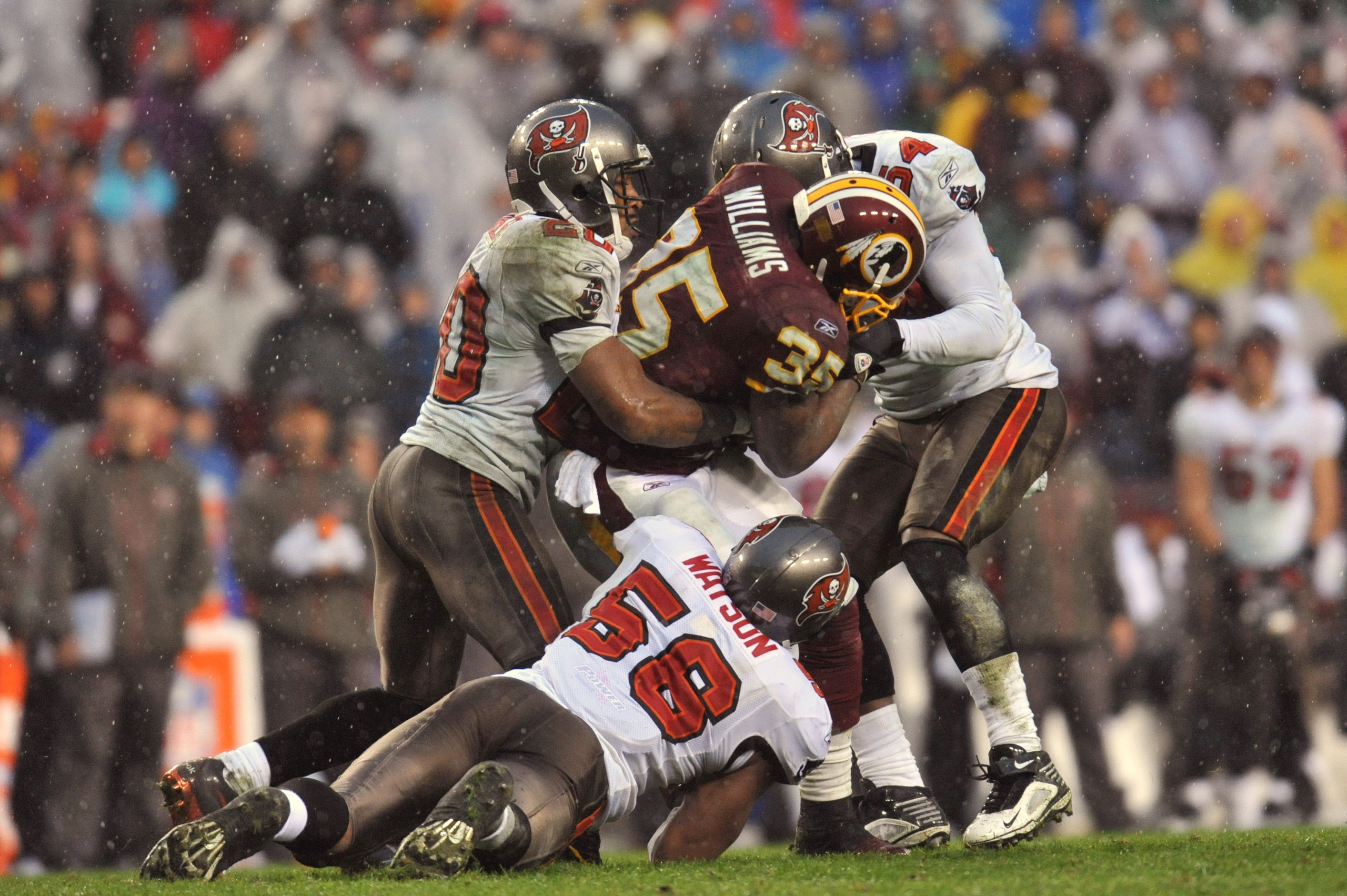 LANDOVER, MD - DECEMBER 12:  Keiland Williams #35 of the Washington Redskins is gang tackled by Ronde Barber #20, Geno Hayes #54 and Dekoda Watson #56 of the Tampa Bay Buccaneers at FedExField on December 12, 2010 in Landover, Maryland. The Buccaneers def