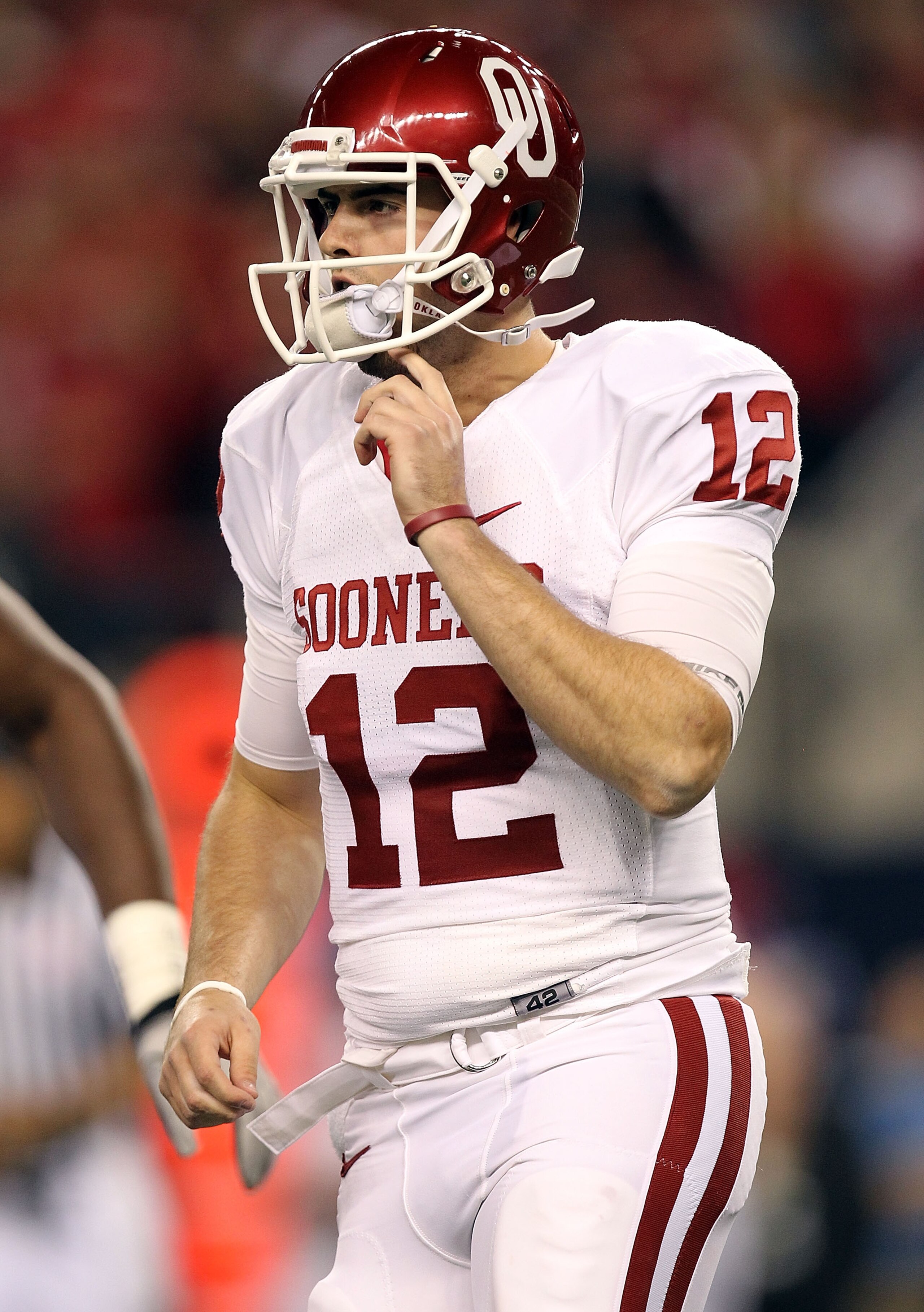 ARLINGTON, TX - DECEMBER 04:  Quarterback Landry Jones #12 of the Oklahoma Sooners drops back to pass against the Nebraska Cornhuskers during the Big 12 Championship at Cowboys Stadium on December 4, 2010 in Arlington, Texas.  (Photo by Ronald Martinez/Ge