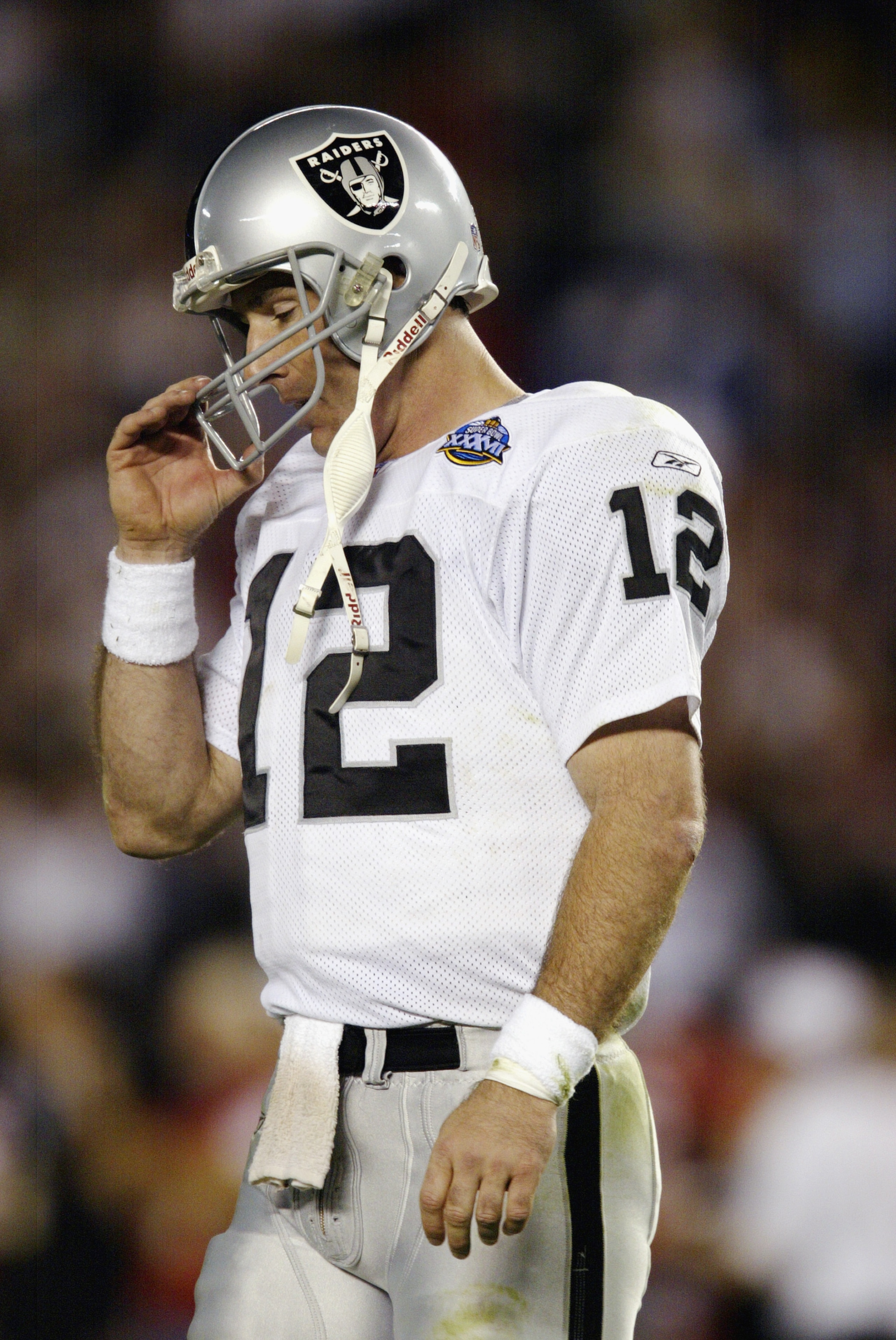 SAN DIEGO - JANUARY 26:  Quarterback Rich Gannon #12 of the Oakland Raiders walks off the field against the Tampa Bay Buccaneers in the fourth quarter of Super Bowl XXXVII on January 26, 2003 at Qualcomm Stadium in San Diego, California. The Buccaneers de
