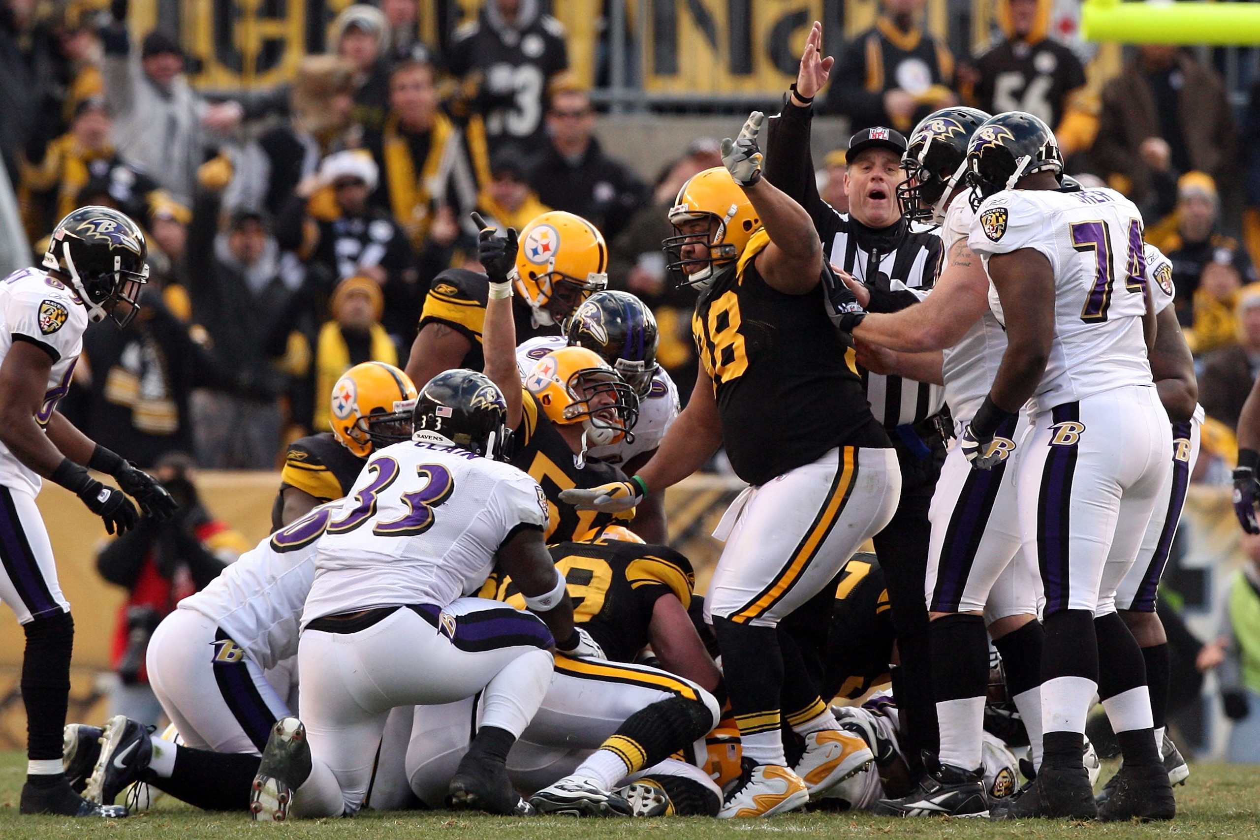 PITTSBURGH - DECEMBER 27:  James Farrior #51 and Casey Hampton #98 signal Ike Taylor's fumble recovery for the Pittsburgh Steelers during the game against the Baltimore Ravens at Heinz Field on December 27, 2009 in Pittsburgh, Pennsylvania.  (Photo by Kar