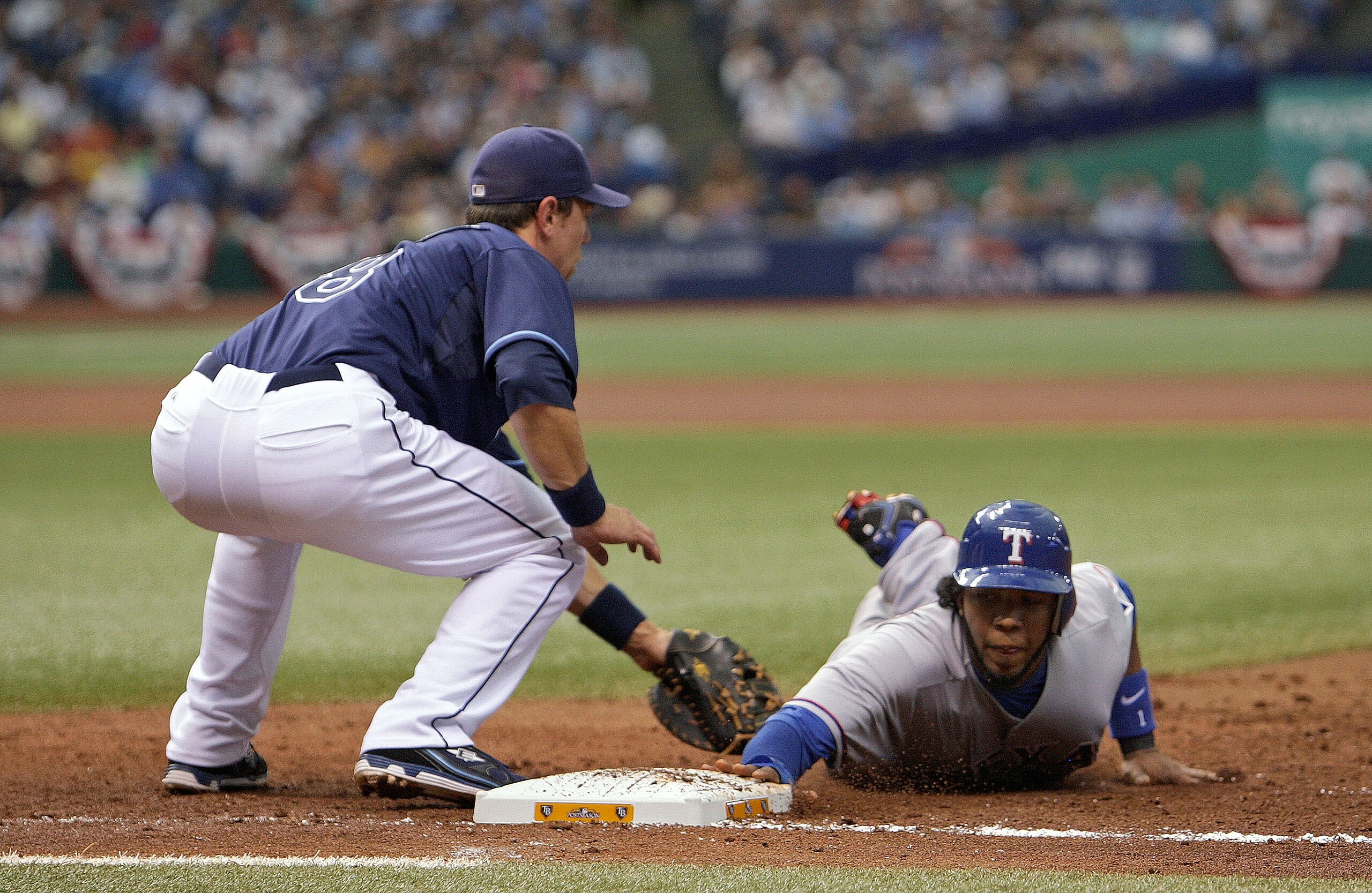 ST PETERSBURG, FL - OCTOBER 07: Elvis Andrus #1 of the Texas Rangers dives back to first as first baseman Ben Zobrist #18 applies the tag during Game 2 of the ALDS against the Tampa Bay Rays at Tropicana Field on October 7, 2010 in St. Petersburg, Florid ST PETERSBURG, FL - OCTOBER 07: Elvis Andrus #1 of the Texas Rangers dives back to first as first baseman Ben Zobrist #18 applies the tag during Game 2 of the ALDS against the Tampa Bay Rays at Tropicana Field on October 7, 2010 in St. Petersburg, Florid