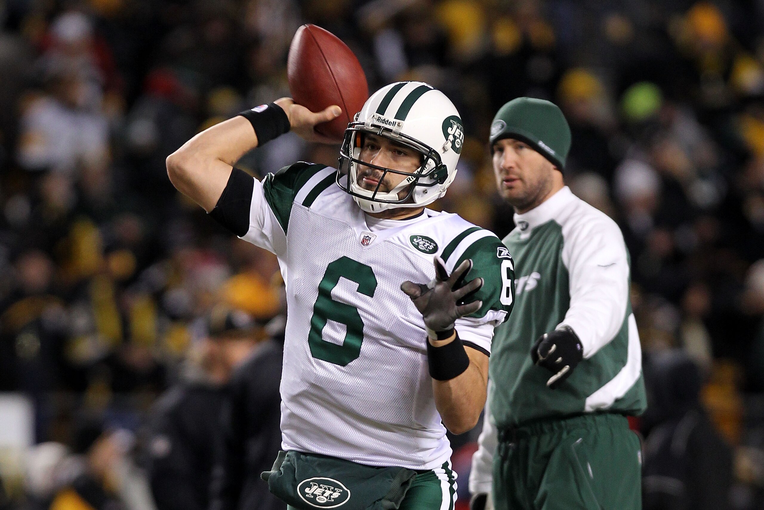 PITTSBURGH, PA - JANUARY 23:  Mark Sanchez #6 of the New York Jets warms up in front of offensive coordinator Brian Schottenheimer against the Pittsburgh Steelers during the 2011 AFC Championship game at Heinz Field on January 23, 2011 in Pittsburgh, Penn