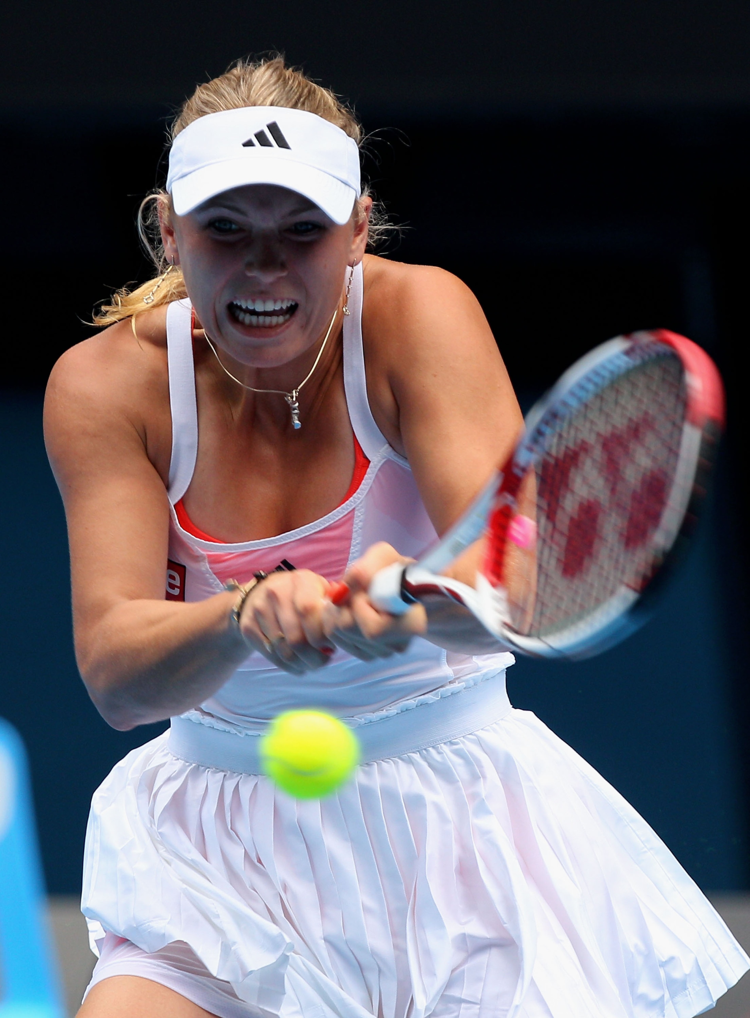 MELBOURNE, AUSTRALIA - JANUARY 21:  Caroline Wozniacki of Denmark plays a backhand in her third round match against  Dominika Cibulkova of Slovakia during day five of the 2011 Australian Open at Melbourne Park on January 21, 2011 in Melbourne, Australia.