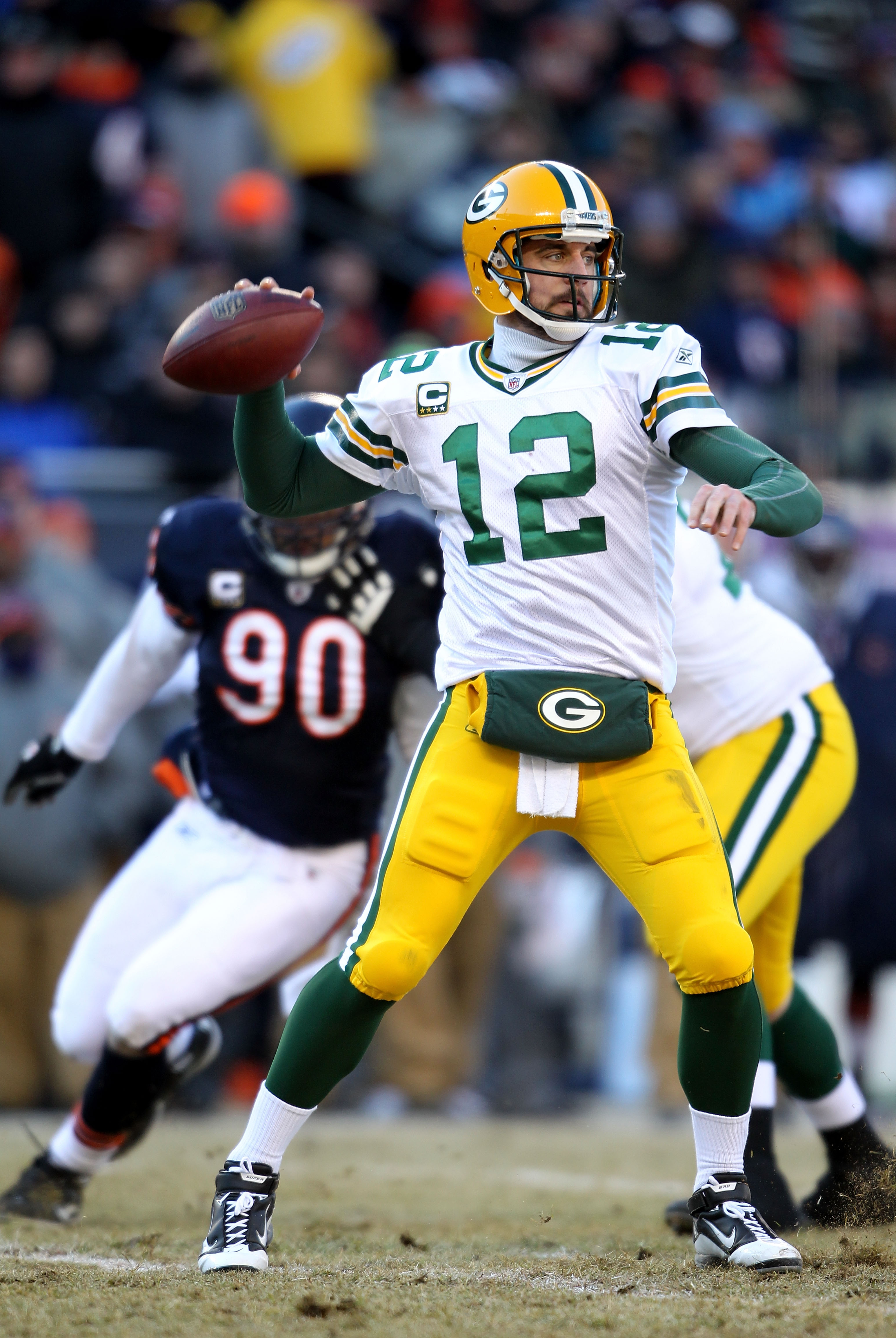 CHICAGO, IL - JANUARY 23:  Quarterback Aaron Rodgers #12 of the Green Bay Packers looks to pass against the Chicago Bears in the NFC Championship Game at Soldier Field on January 23, 2011 in Chicago, Illinois.  (Photo by Andy Lyons/Getty Images)