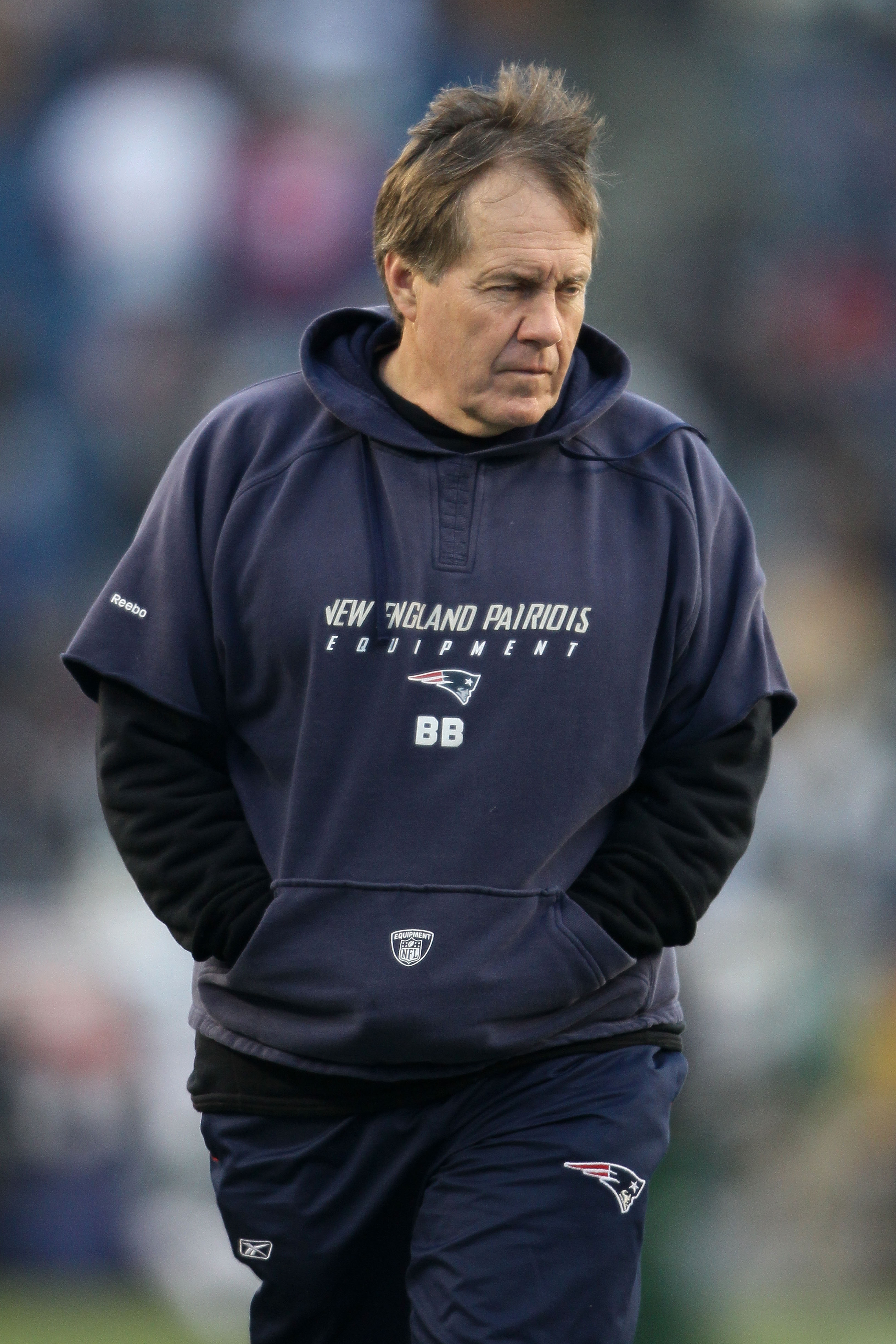 FOXBORO, MA - JANUARY 16:  Head coach Bill Belichick of the New England Patriots stands on the field during their 2011 AFC divisional playoff game against the New York Jets at Gillette Stadium on January 16, 2011 in Foxboro, Massachusetts.  (Photo by Elsa