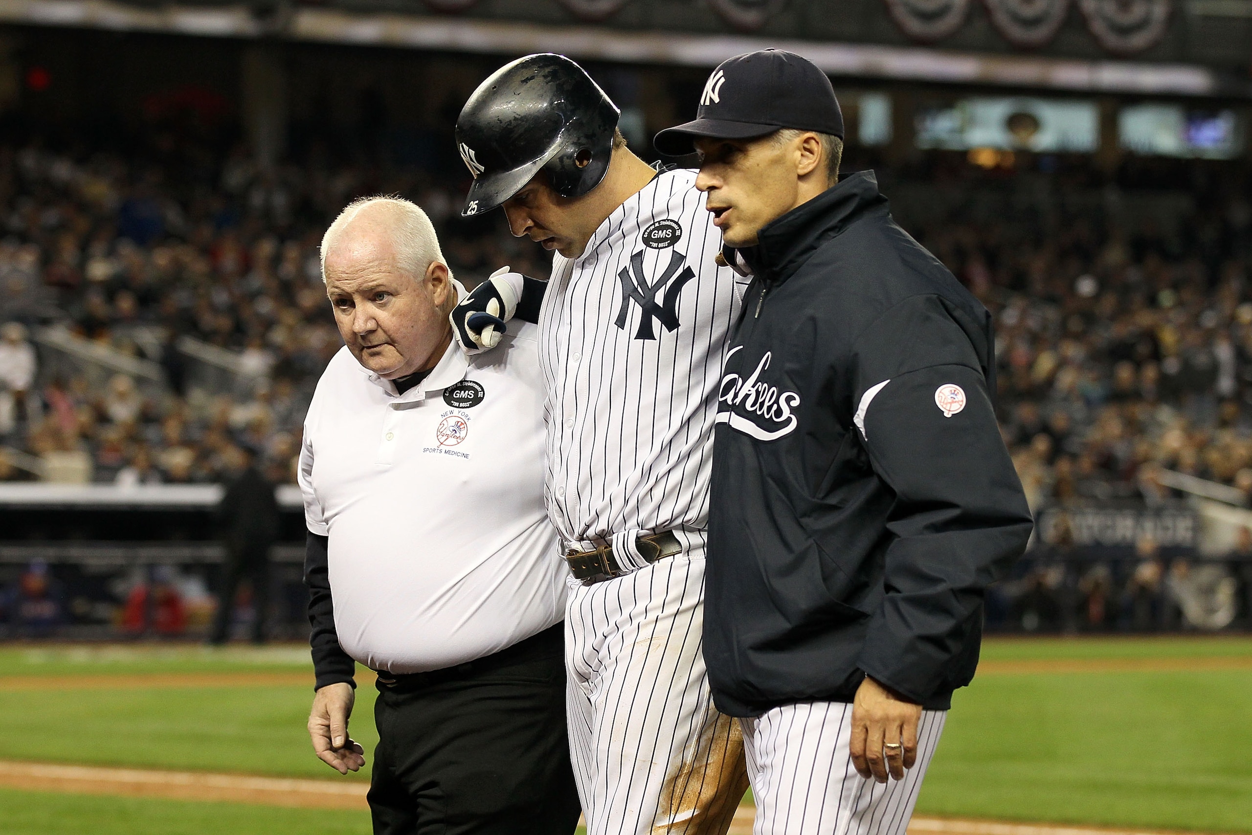 NEW YORK - OCTOBER 19:  Mark Teixeira #25 of the New York Yankees is helped off of the field by Manager Joe Girardi and a trainer after hurting himself while playing against the Texas Rangers in Game Four of the ALCS during the 2010 MLB Playoffs at Yankee