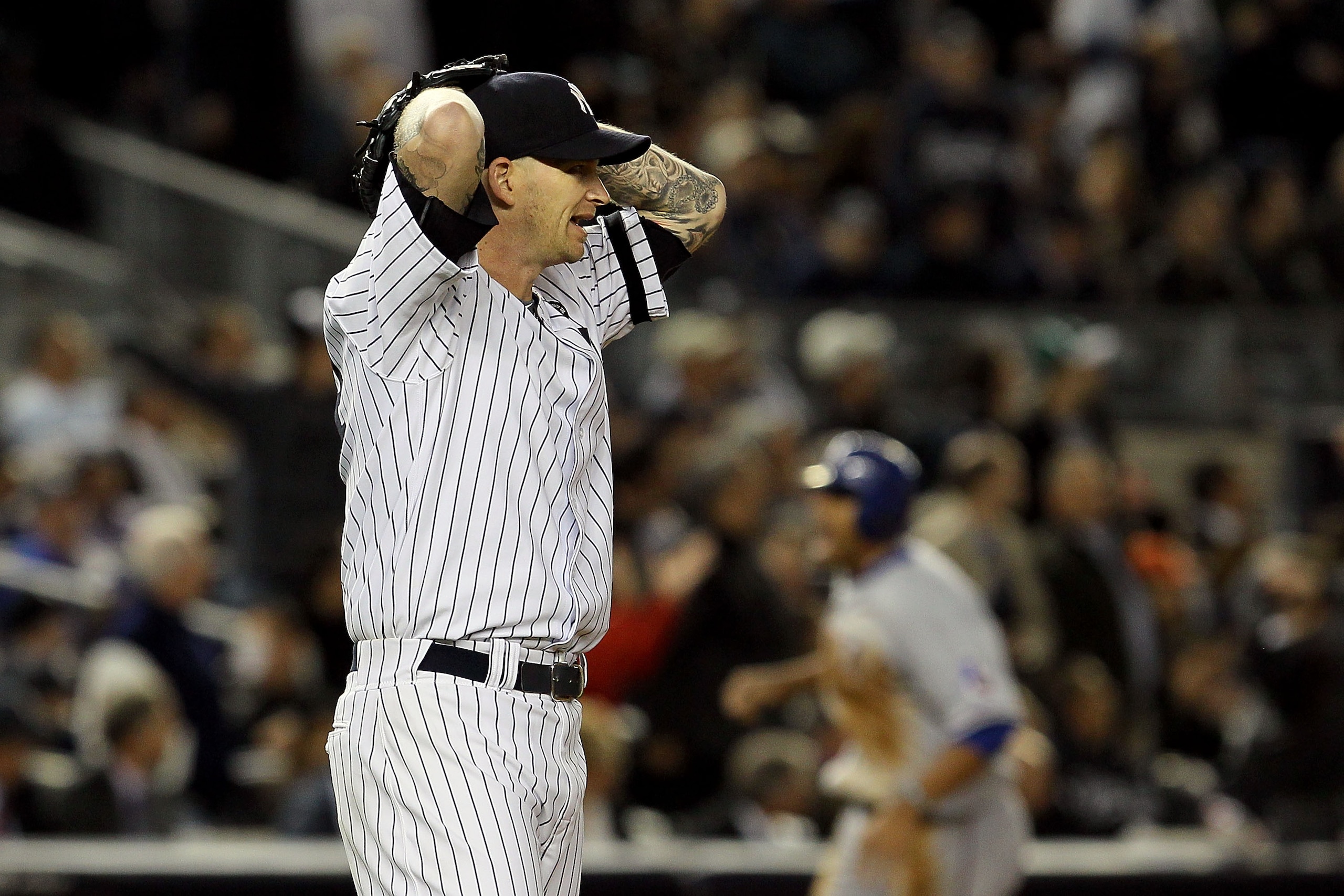NEW YORK - OCTOBER 19:  A.J. Burnett #34 of the New York Yankees reacts after giving up a three-run home run to Bengie Molina #11 of the Texas Rangers in the top of the sixth inning in Game Four of the ALCS during the 2010 MLB Playoffs at Yankee Stadium o